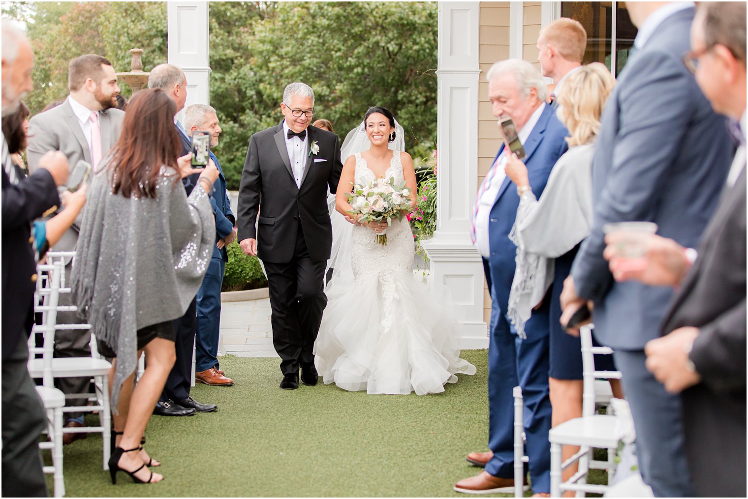 bride and dad enter wedding ceremony at Clarks Landing