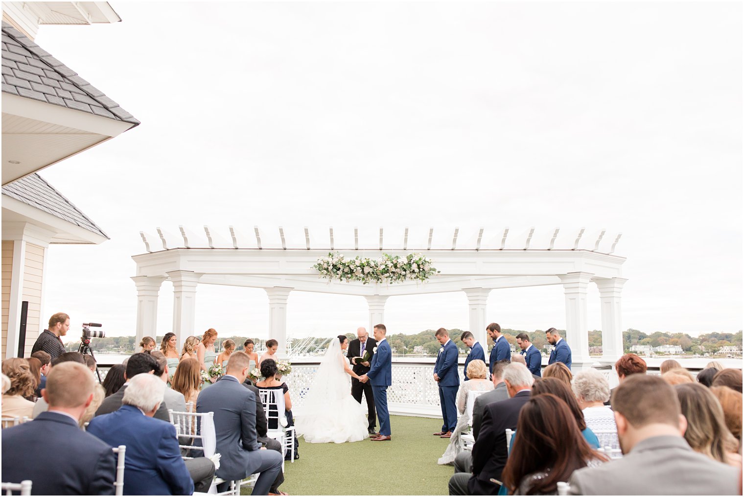 newlyweds exchange vows during Clarks Landing ceremony overlooking water
