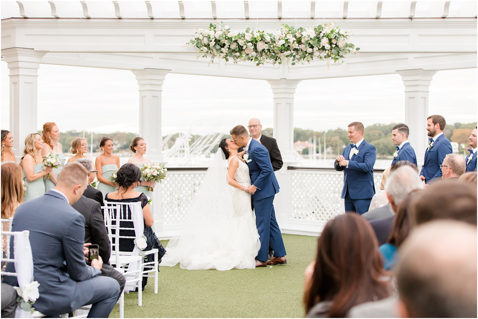 bride and groom kiss during ceremony at Clarks Landing