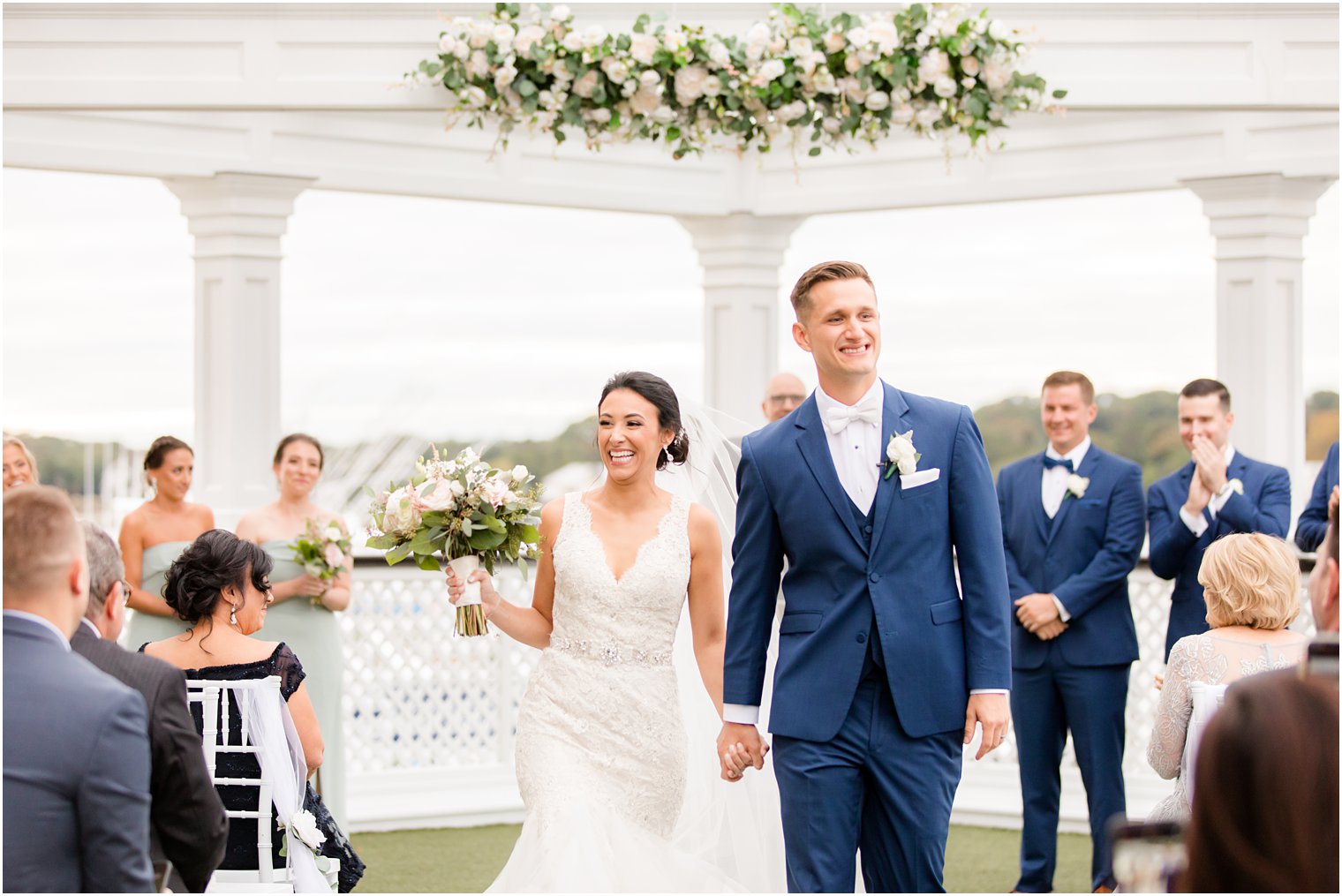 newlyweds smile leaving ceremony at Clarks Landing