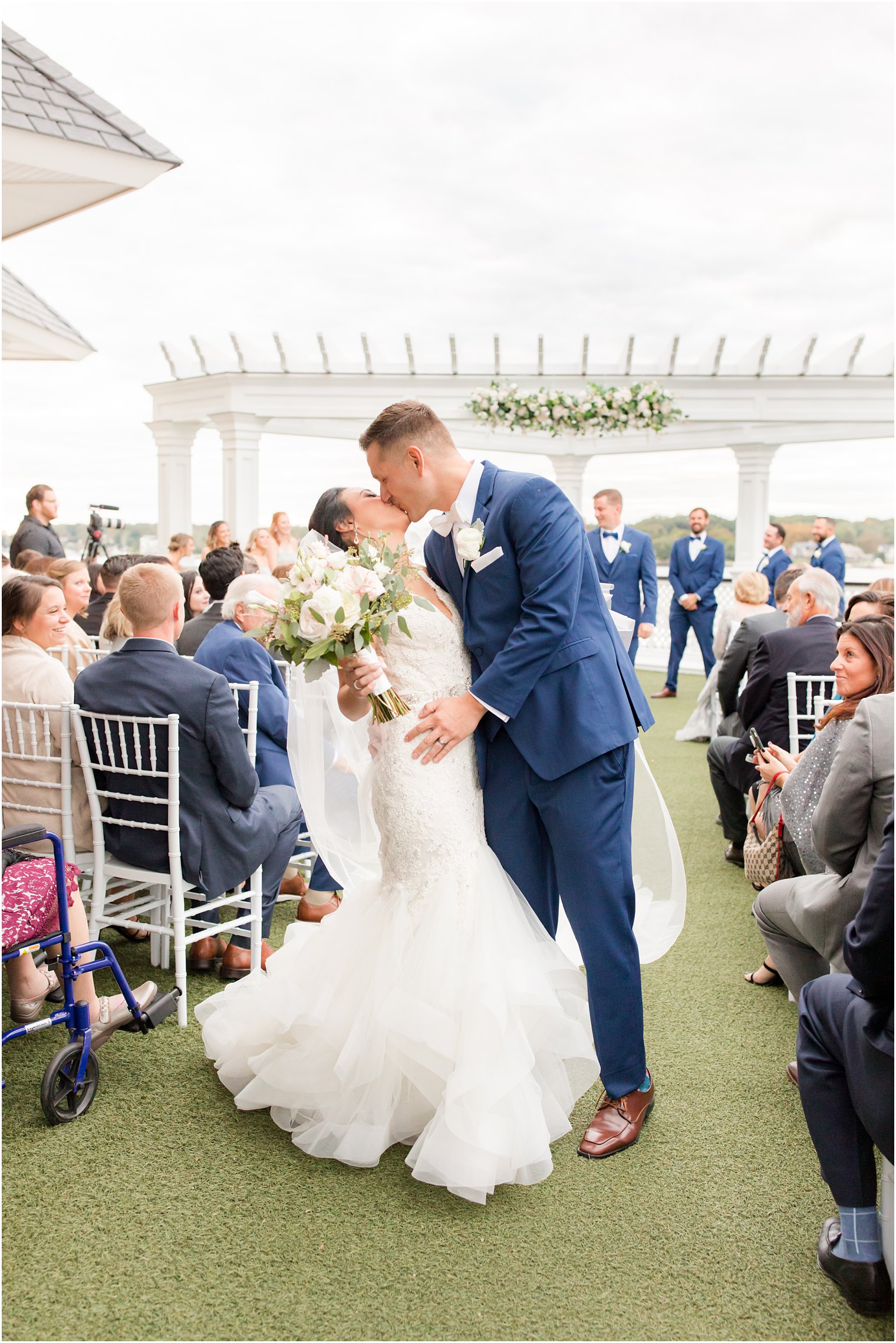 bride and groom kiss leaving Clarks Landing wedding ceremony