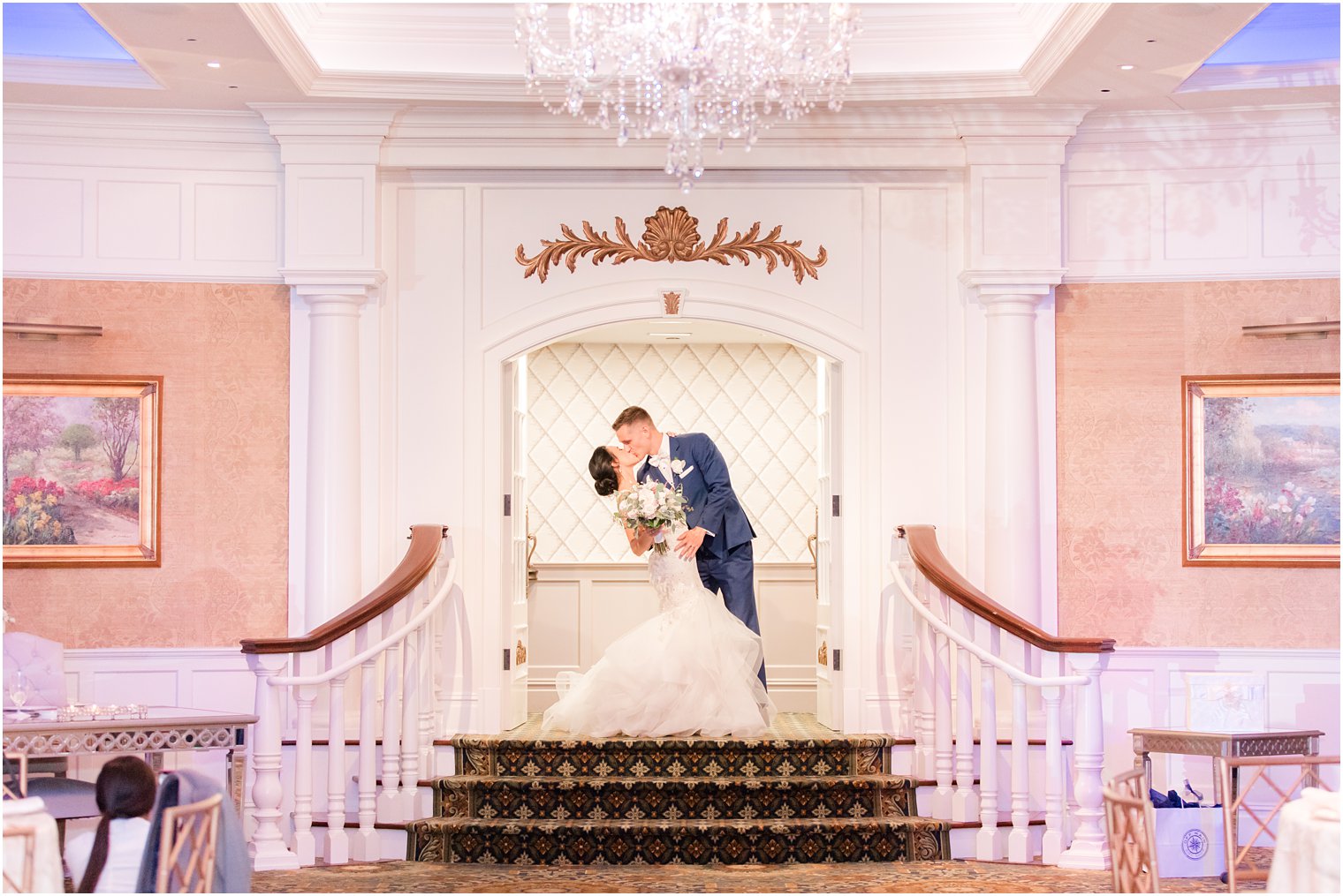 bride and groom kiss on staircase at Clarks Landing