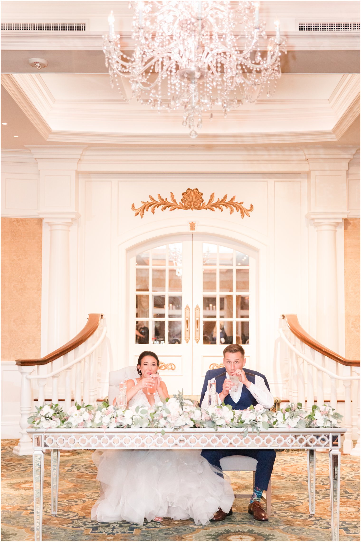 newlyweds sit at sweetheart table during Delran NJ wedding reception