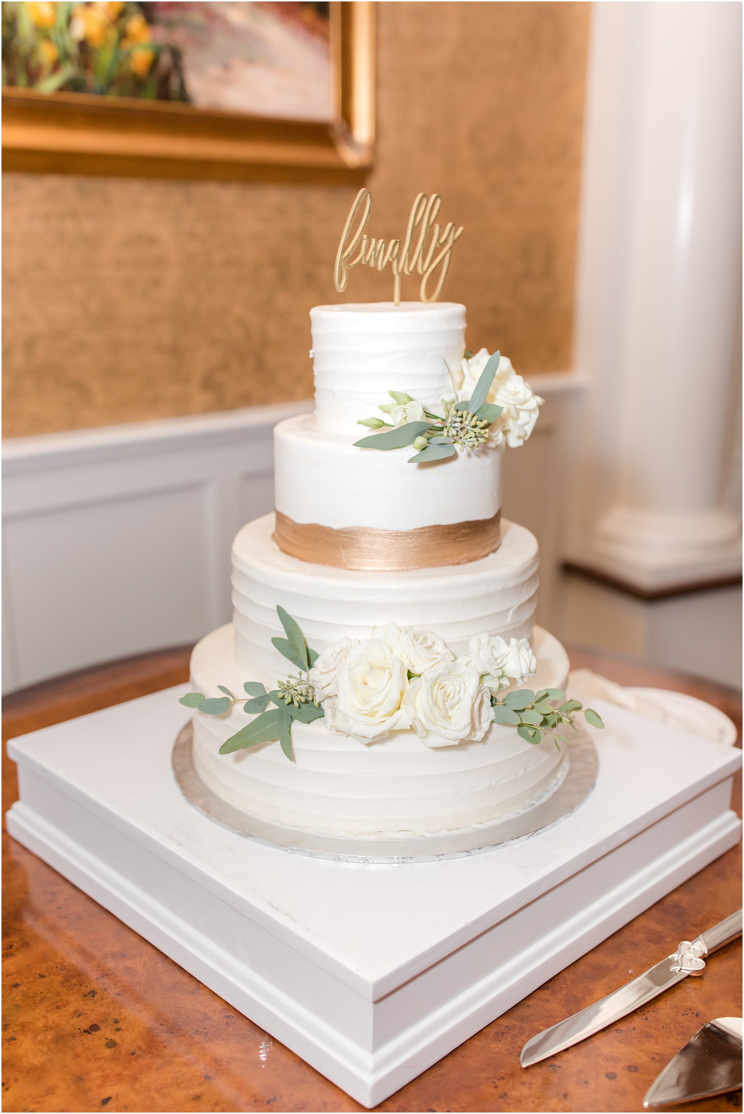 tiered wedding cake with copper detail 