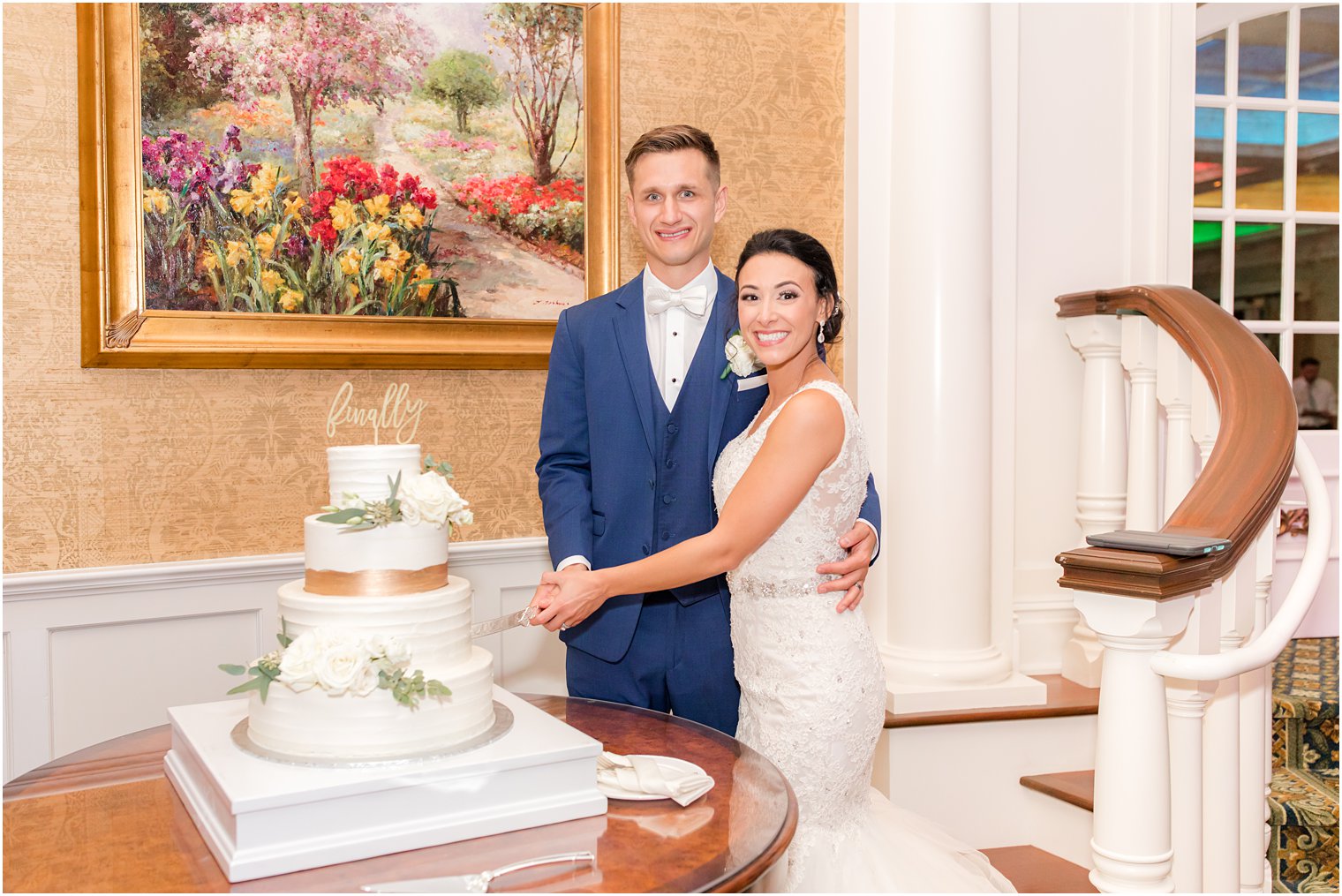 newlyweds cut wedding cake during Delran NJ wedding reception