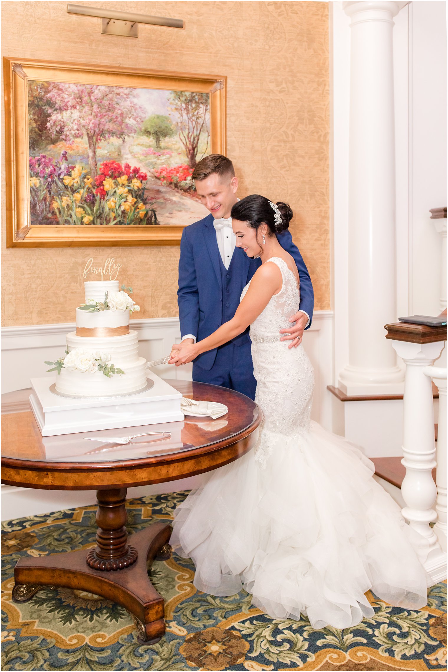 bride and groom cut wedding cake during Clarks Landing wedding reception