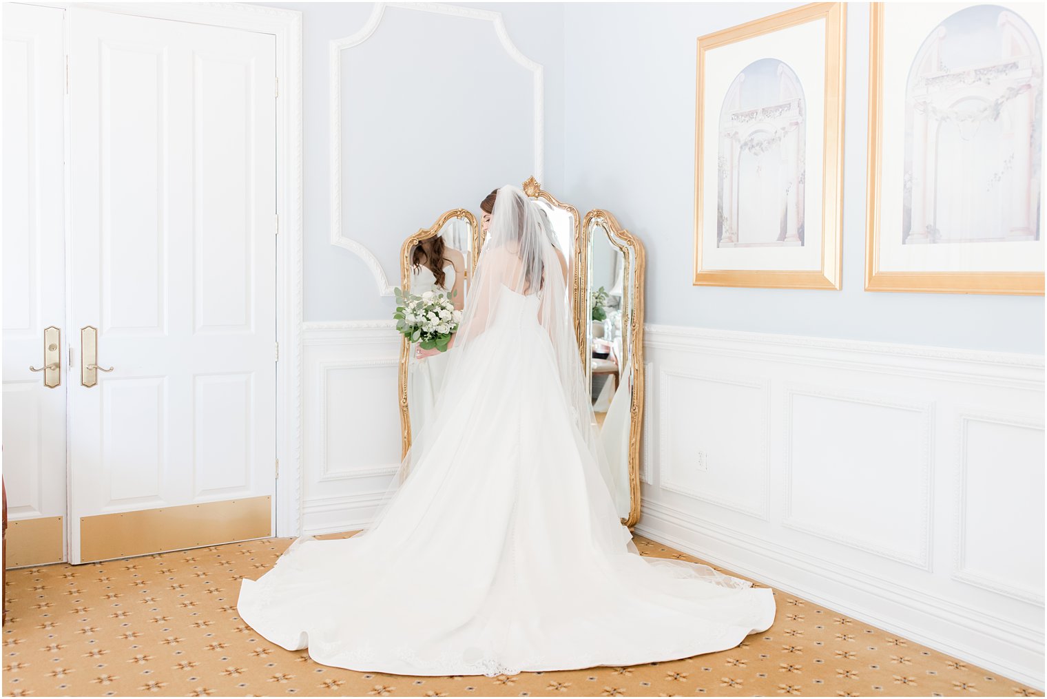 bride looks over shoulder holding bouquet during Farmingdale NJ wedding day