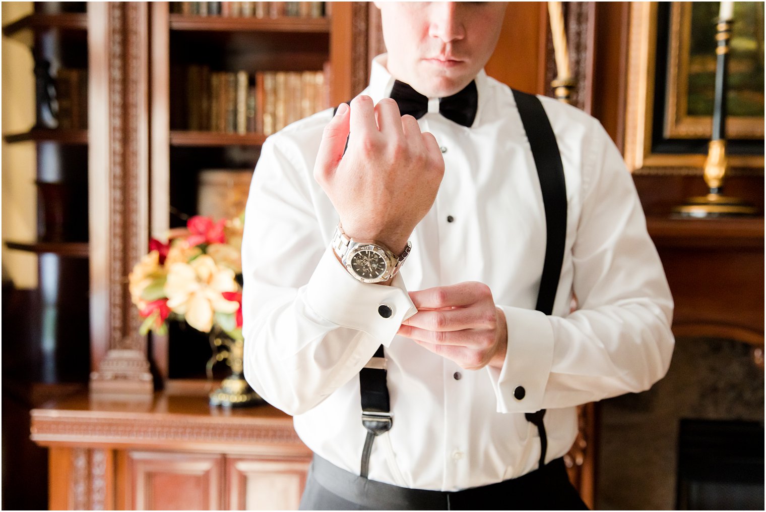 groom adjusts cufflinks before Eagle Oaks wedding day