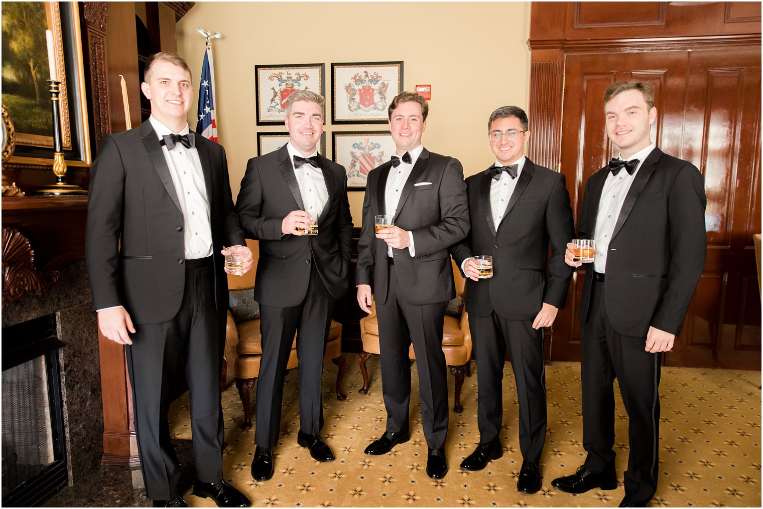 groom poses with four groomsmen in classic tuxes at Eagle Oaks