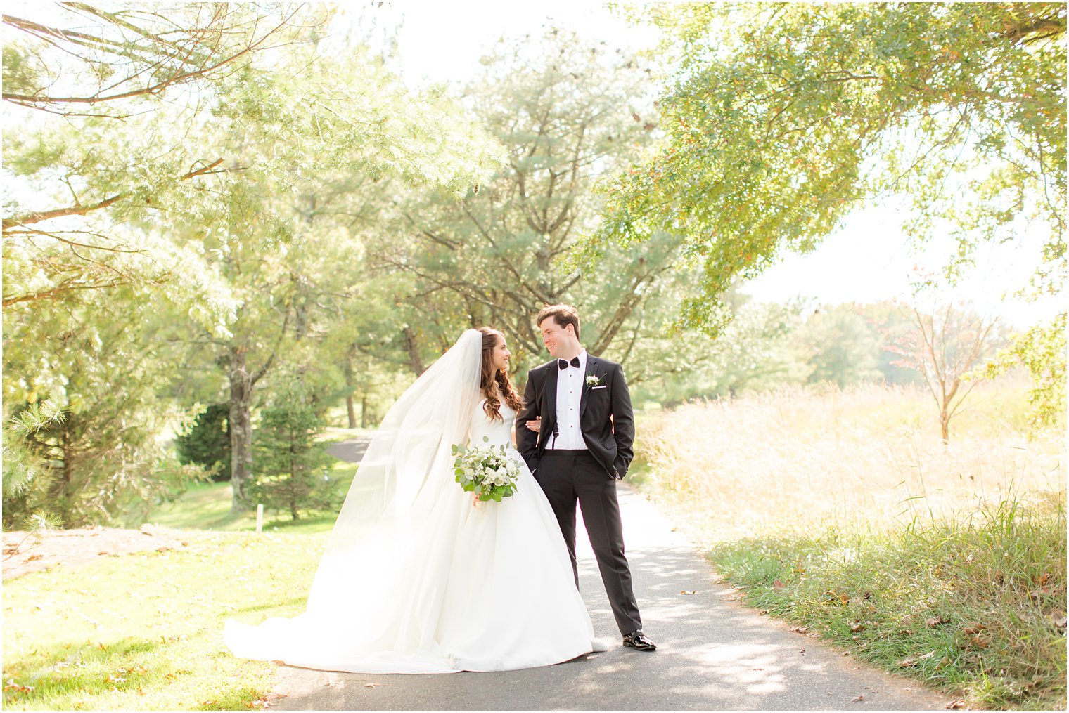 newlyweds pose on walkway at Eagle Oaks Golf and Country Club