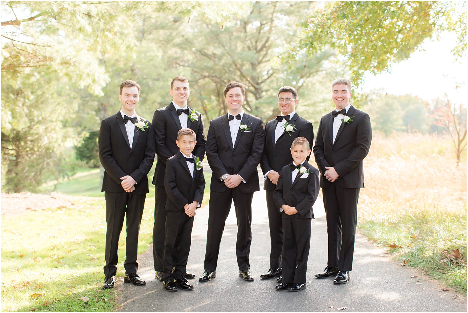 groom and groomsmen pose with ring bearers at Eagle Oaks Golf and Country Club