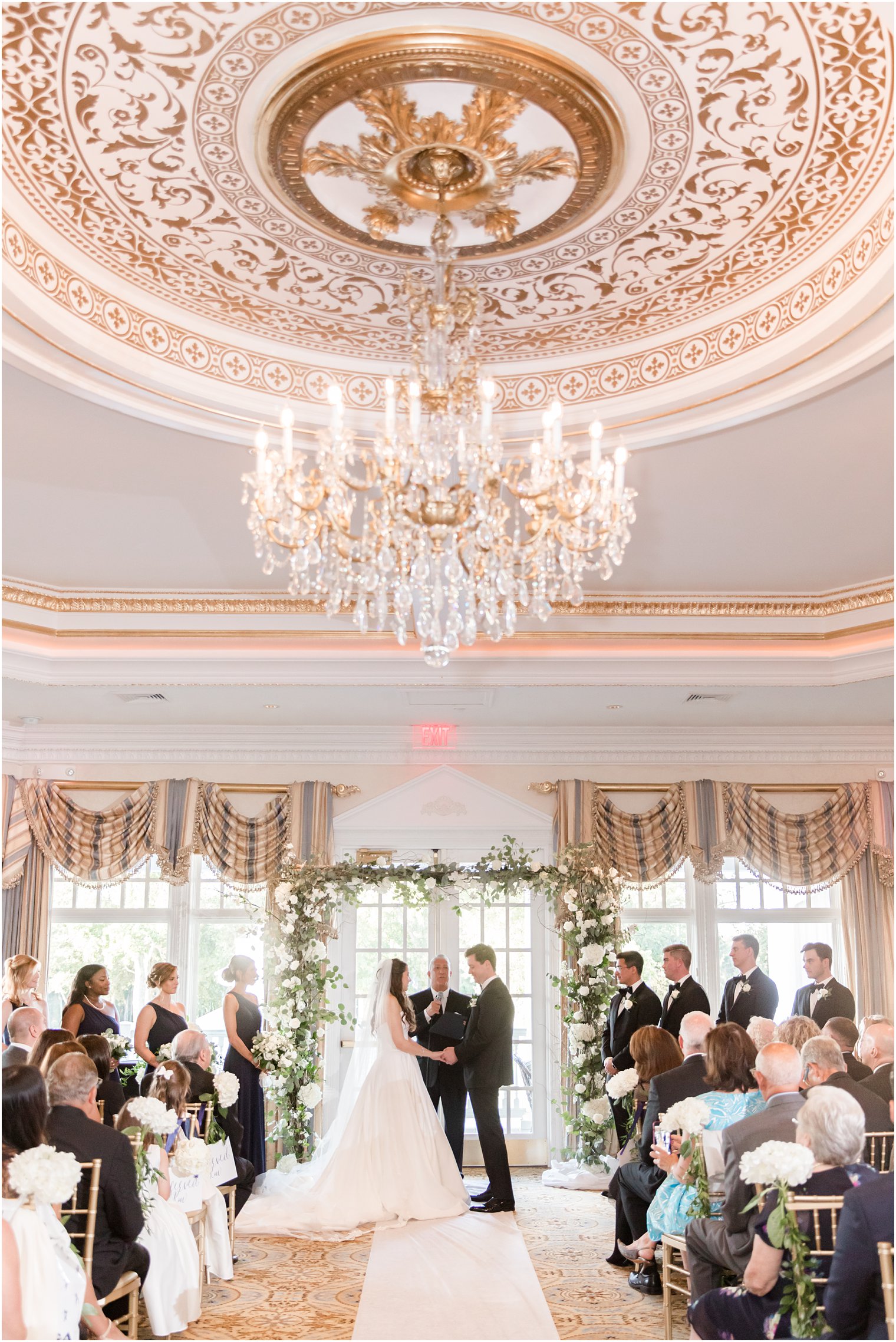 newlyweds hold hands during ceremony at Eagle Oaks Golf and Country Club