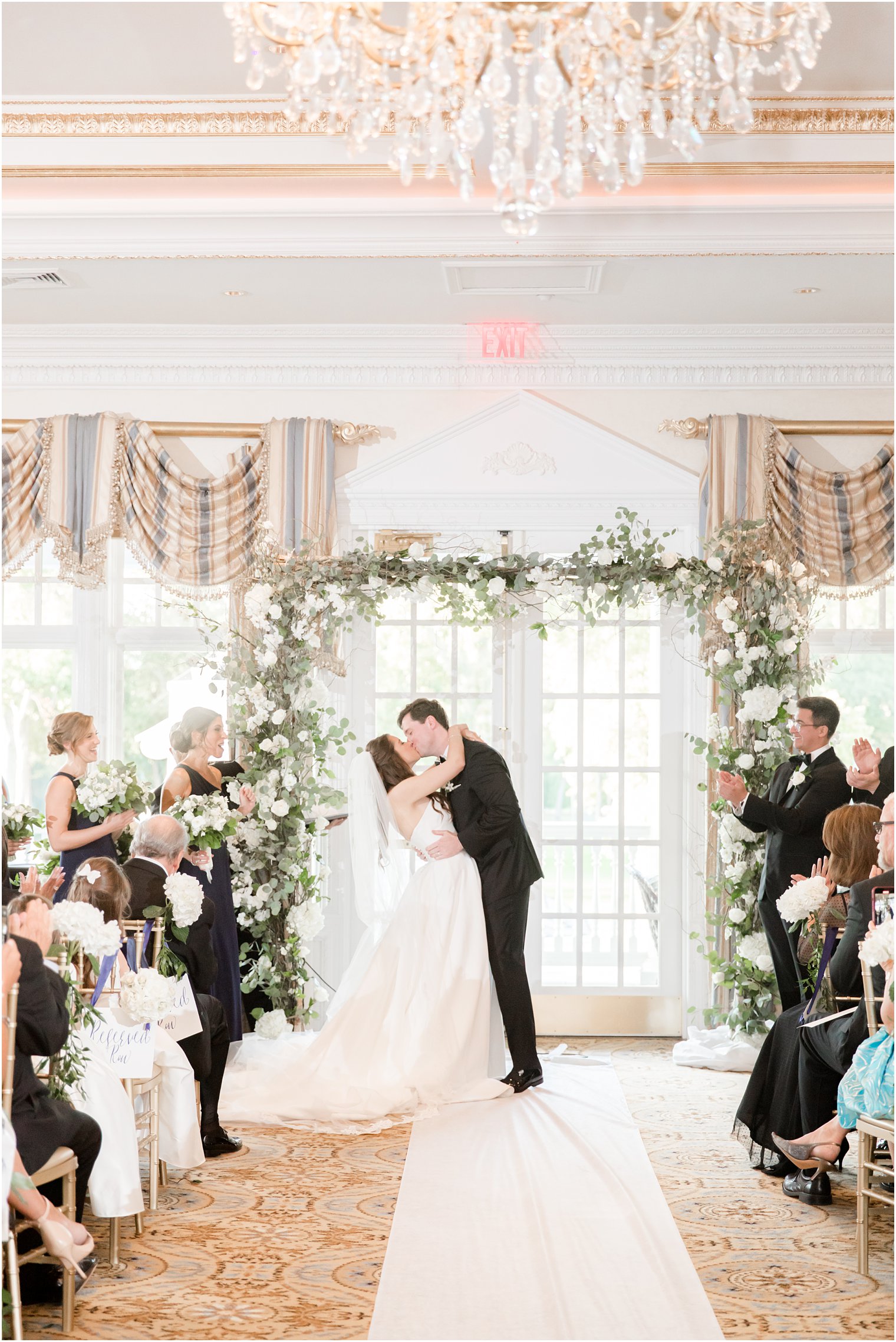 newlyweds kiss during Eagle Oaks Golf and Country Club wedding ceremony 
