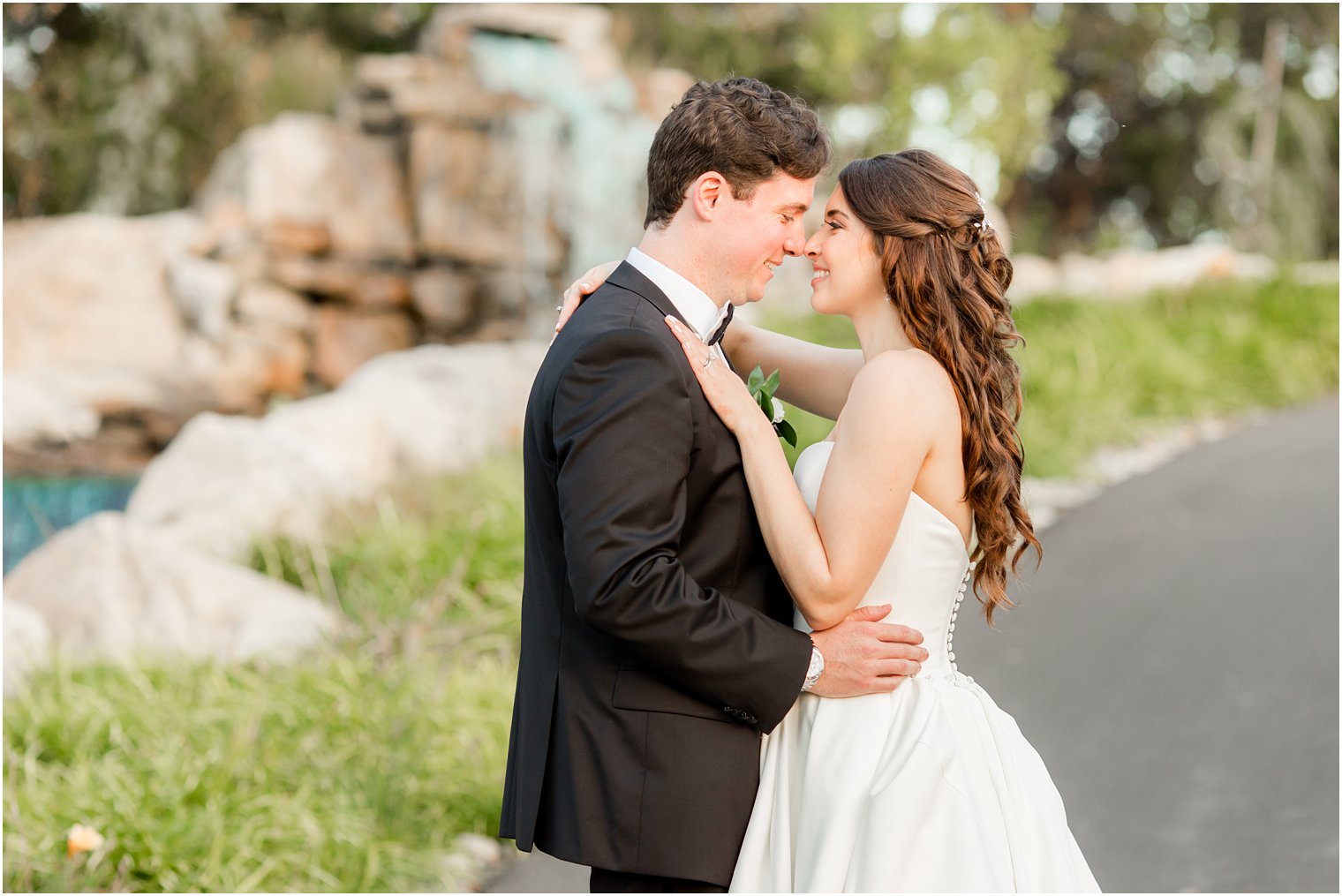 bride and groom pose on pathway in Farmingdale NJ