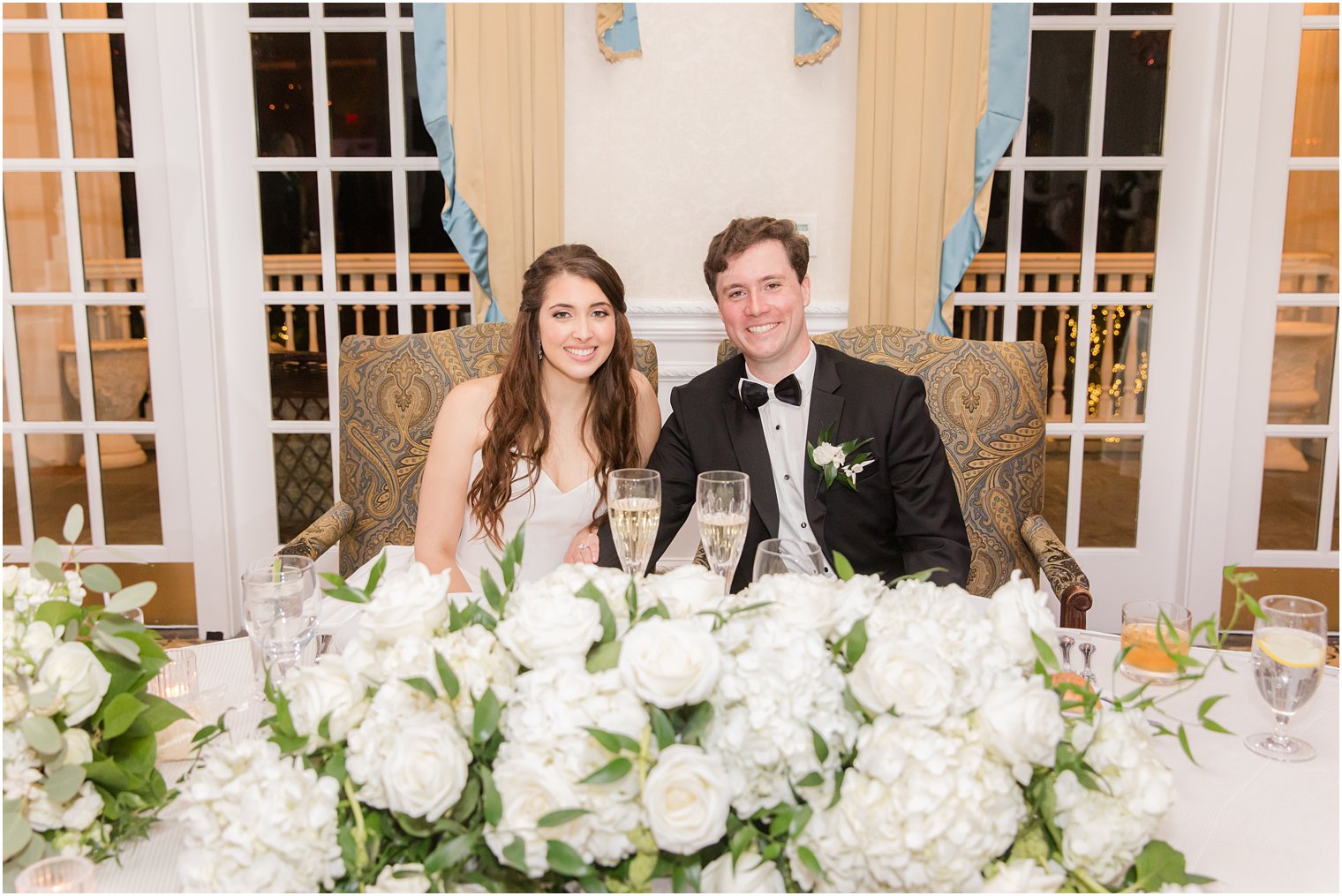 newlyweds sit at sweetheart table during 