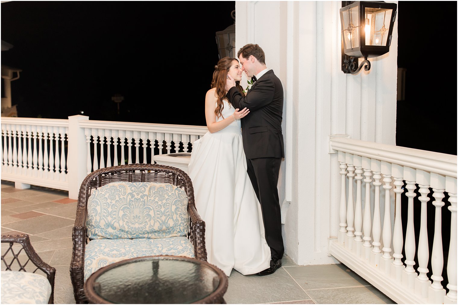 newlyweds kiss on balcony at Eagle Oaks Golf and Country Club