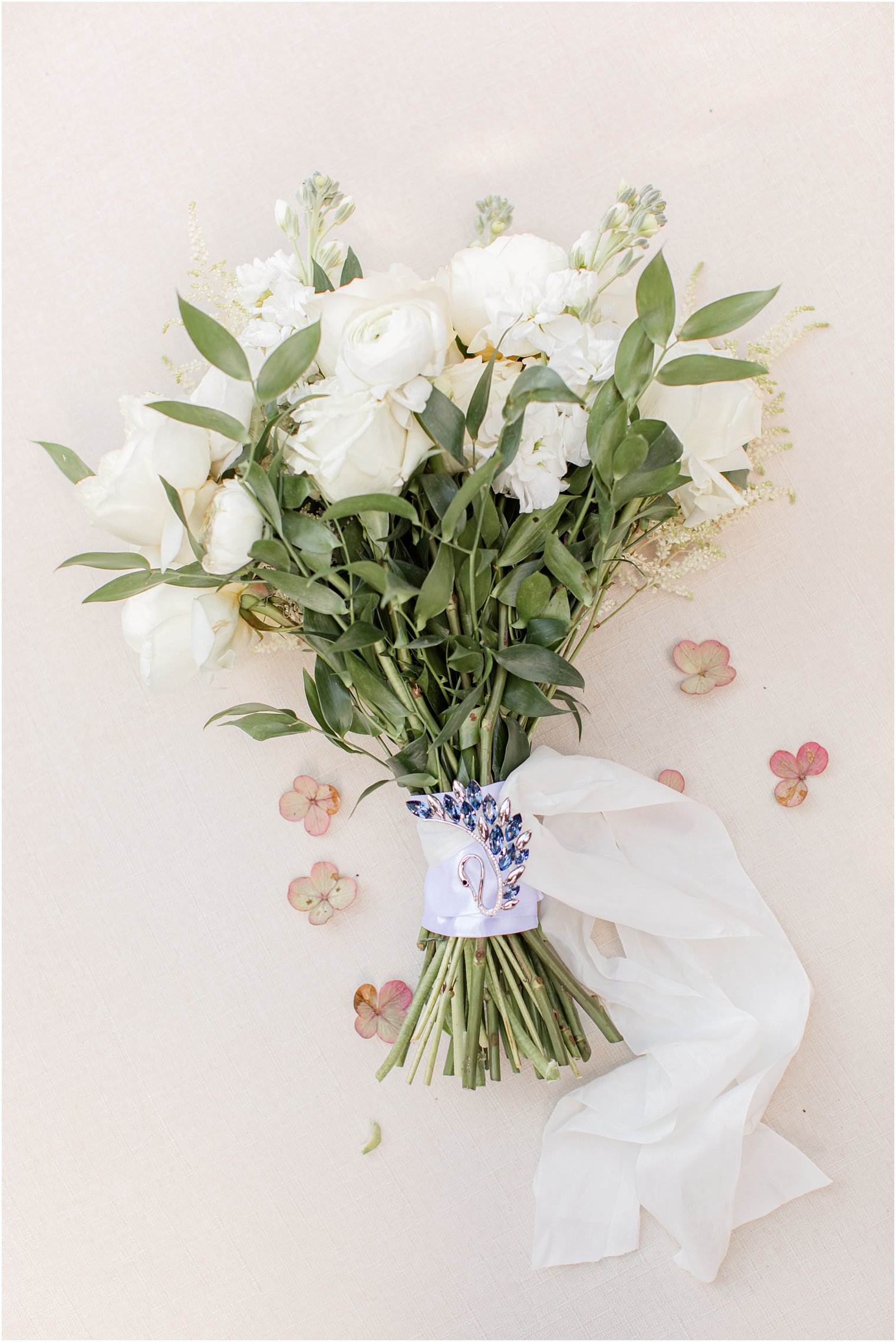 bride's bouquet with custom brooch on handle