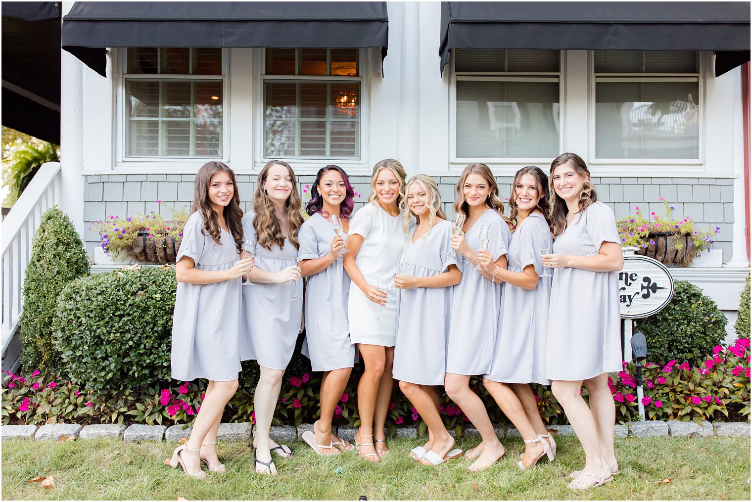 bride and bridesmaids pose outside the Mill Lakeside Manor
