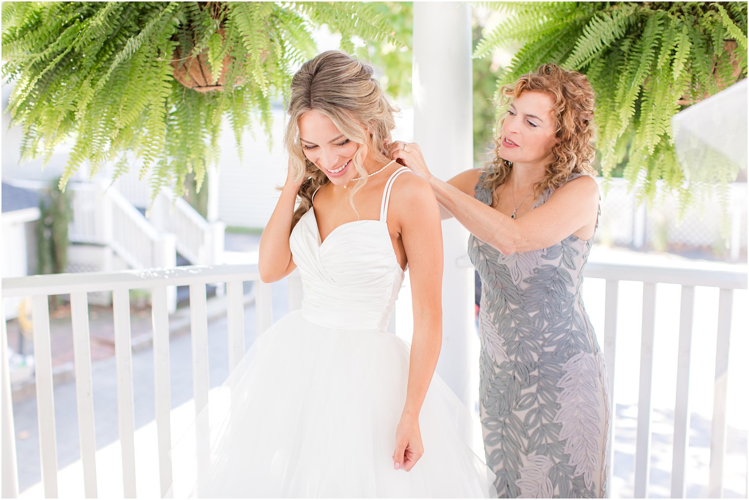 mom helps bride with wedding gown in New Jersey