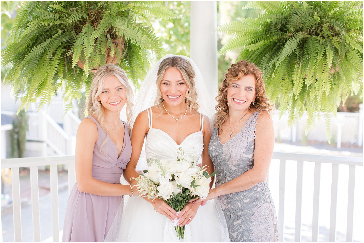 bride poses with mom and sister before NJ wedding