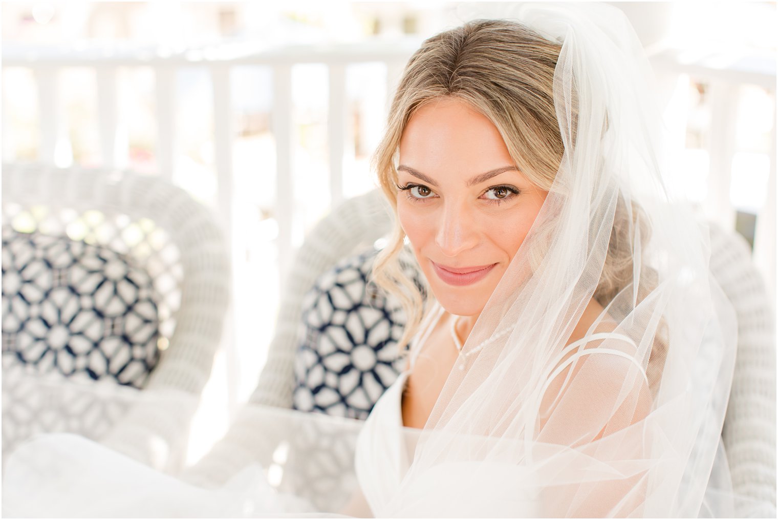 bride sits in wicker chair in New Jersey