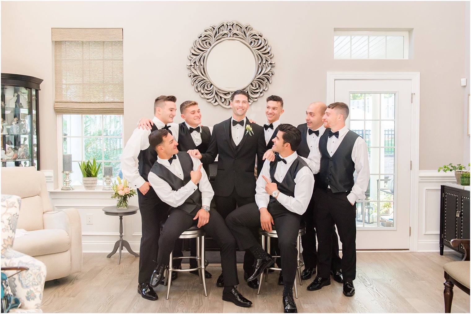 groom and groomsmen pose in living room