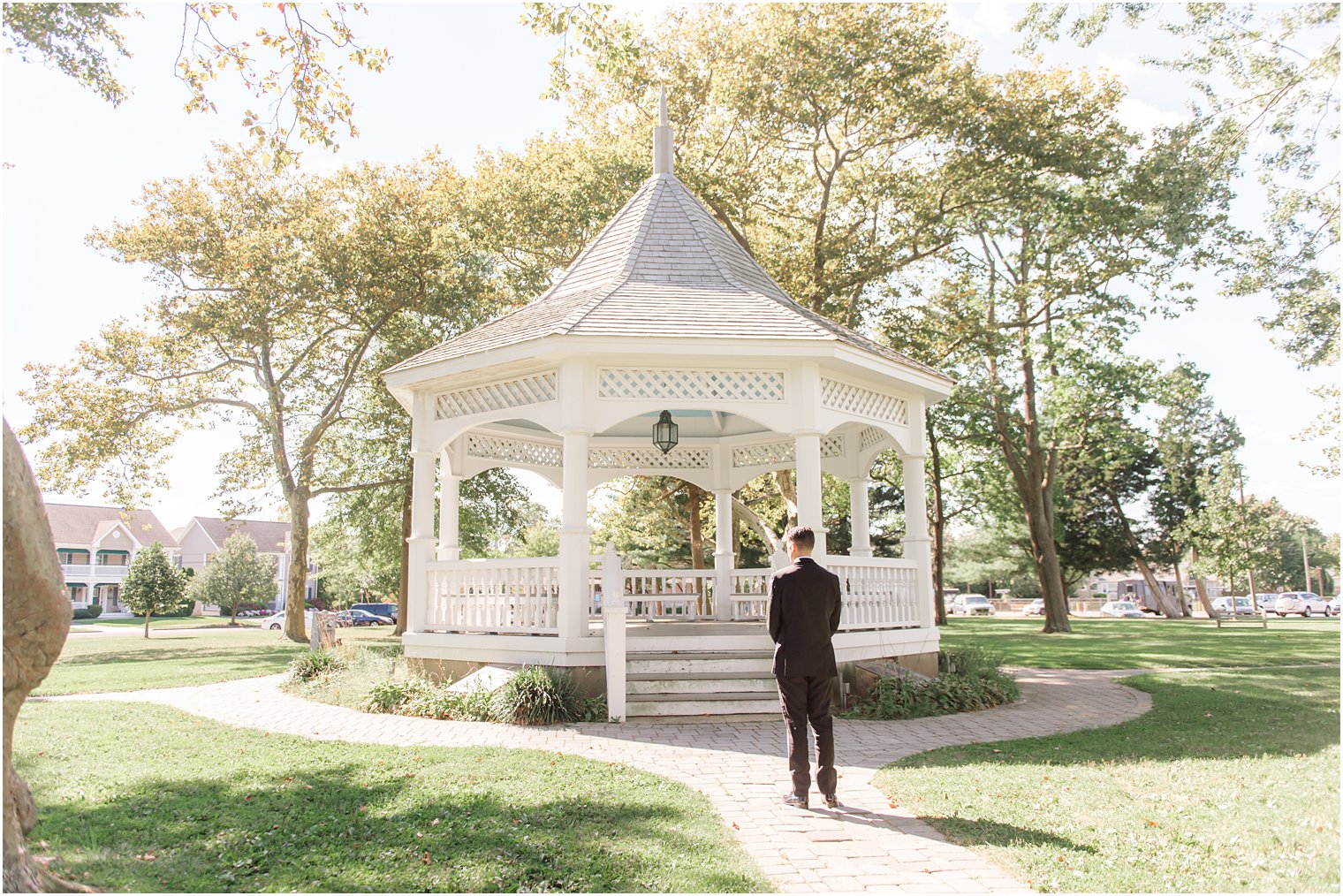 bride approaches groom at gazebo for first look