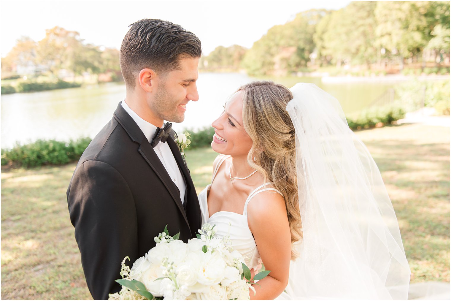 newlyweds smile at each other during first look