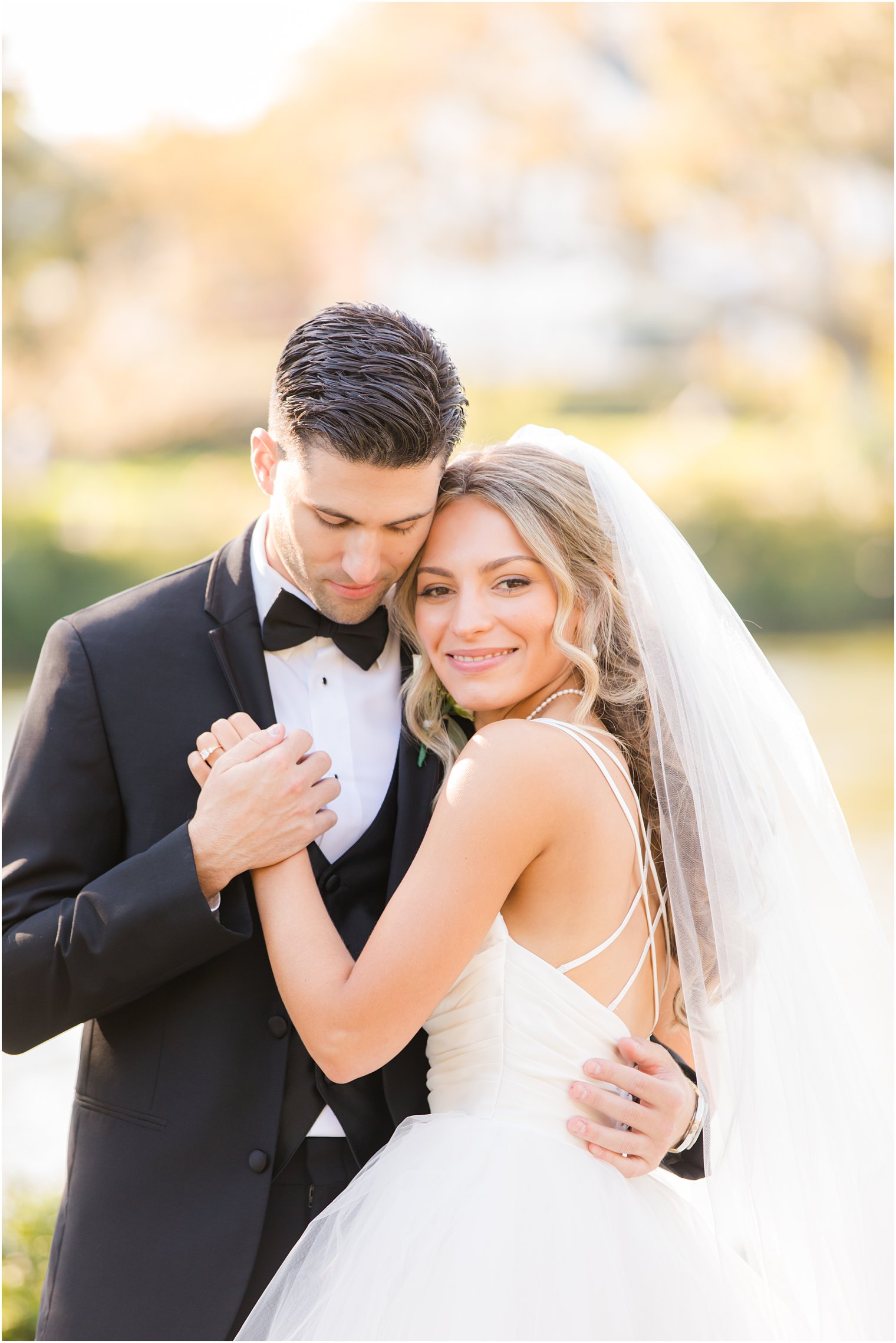 bride hugs groom during wedding photos in Spring Lake NJ