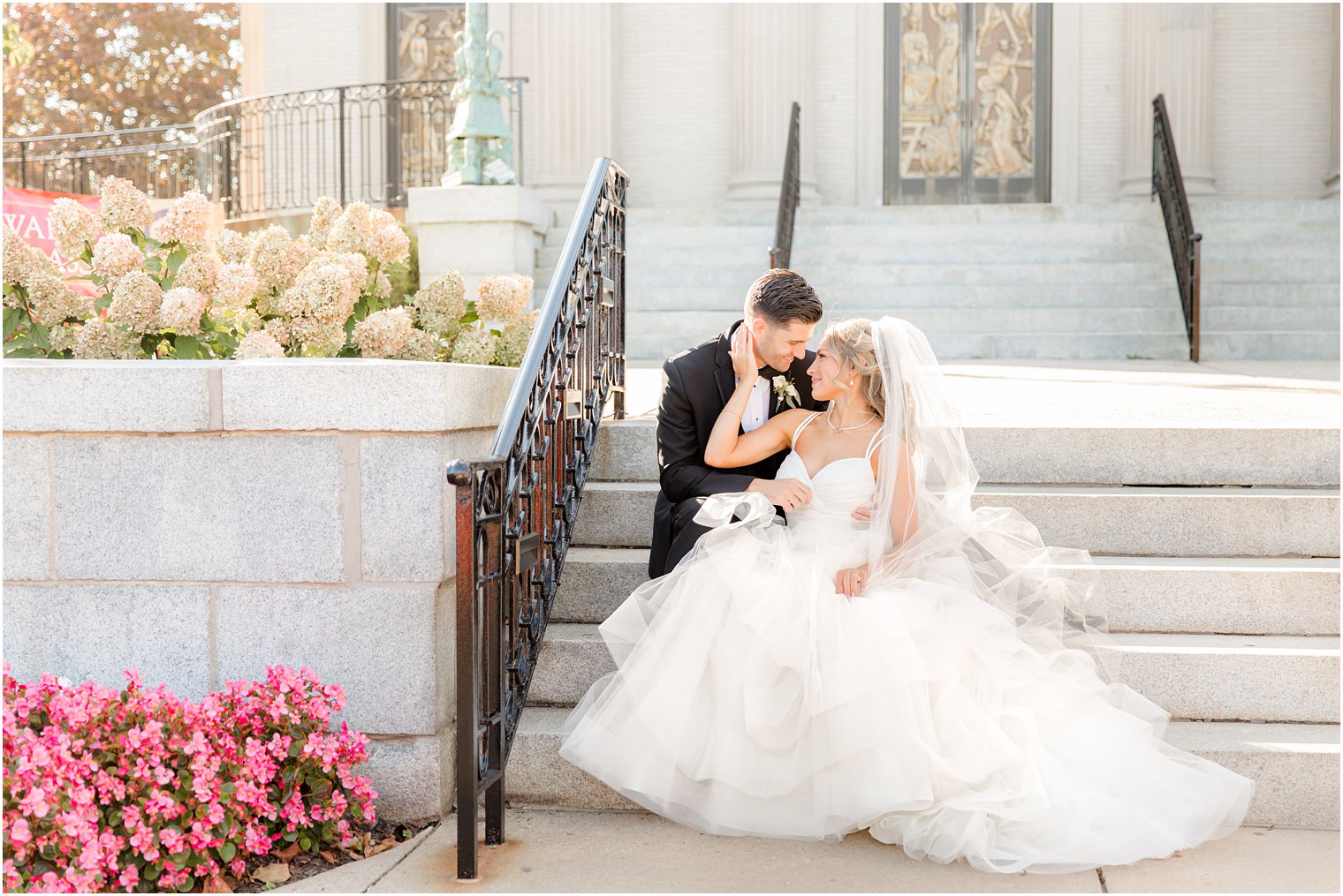 newlyweds sit on steps in Spring Lake NJ