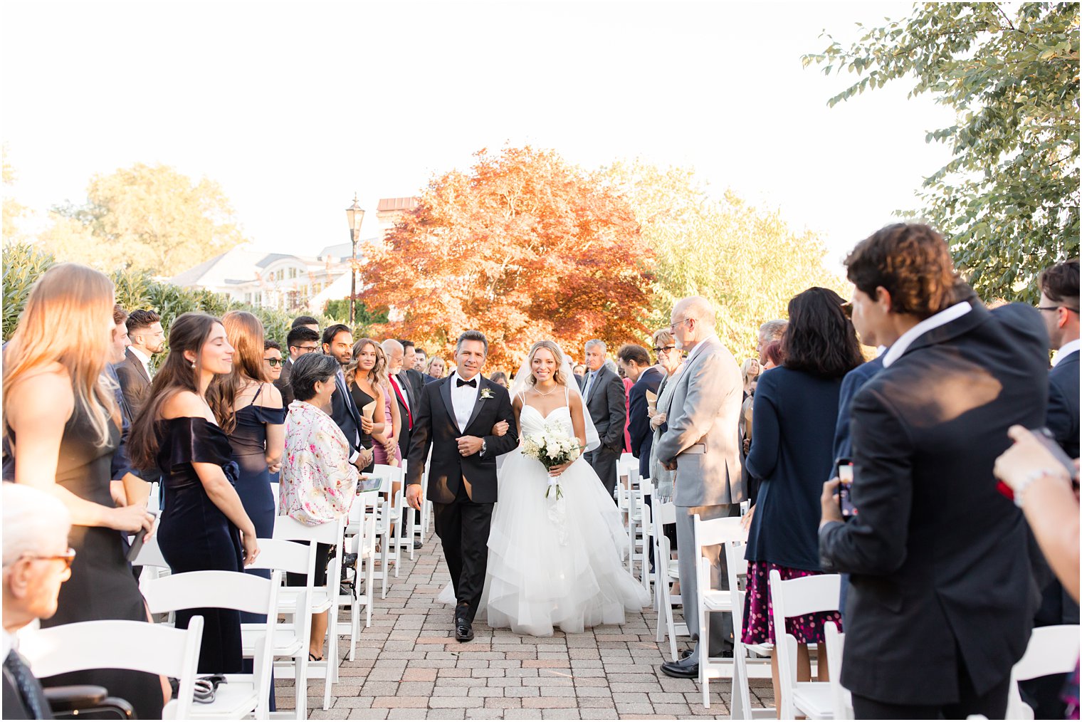 bride and dad walk up aisle at the Mill Lakeside Manor