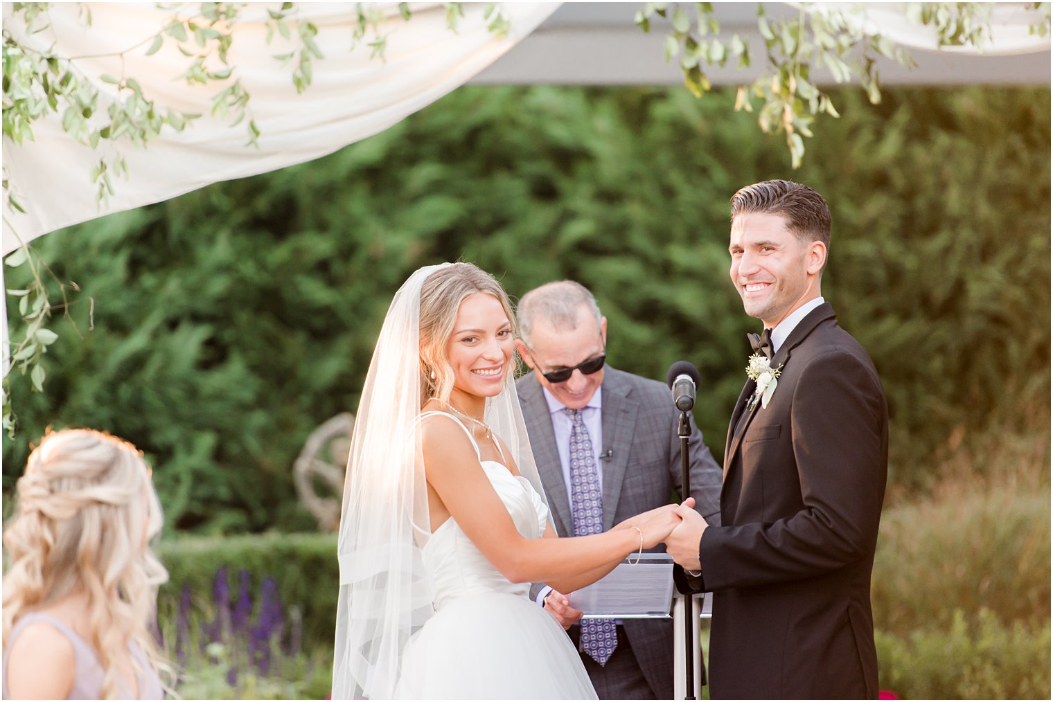 newlyweds laugh during ceremony at the Mill Lakeside Manor
