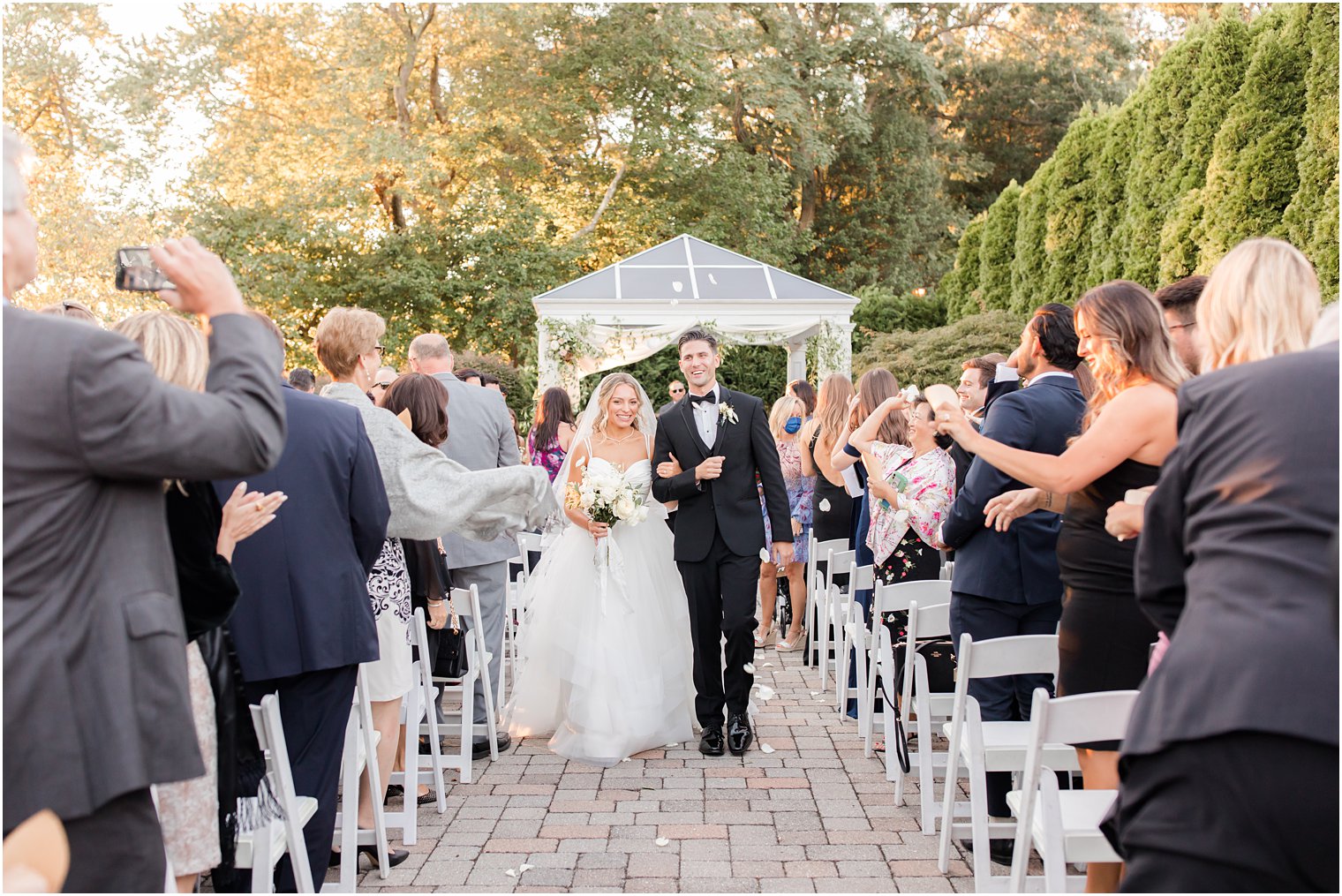 newlyweds walk up aisle after ceremony at the Mill Lakeside Manor