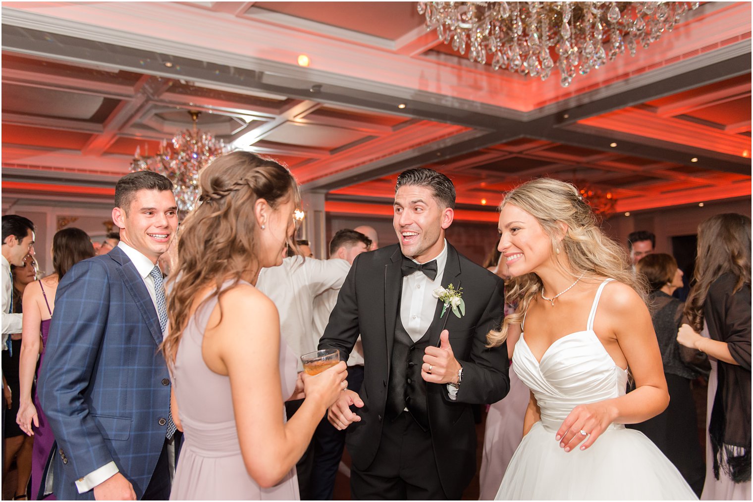 bride and groom walk with wedding guests during Spring Lake NJ wedding reception 