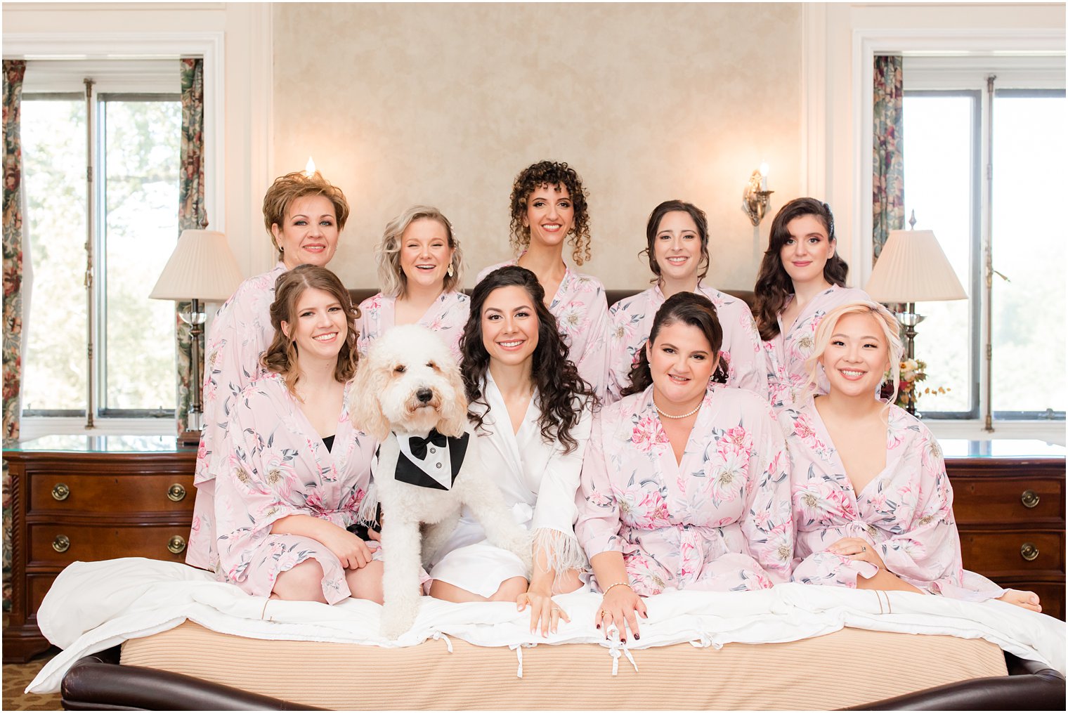 bride sits with bridesmaids and dog before NY wedding