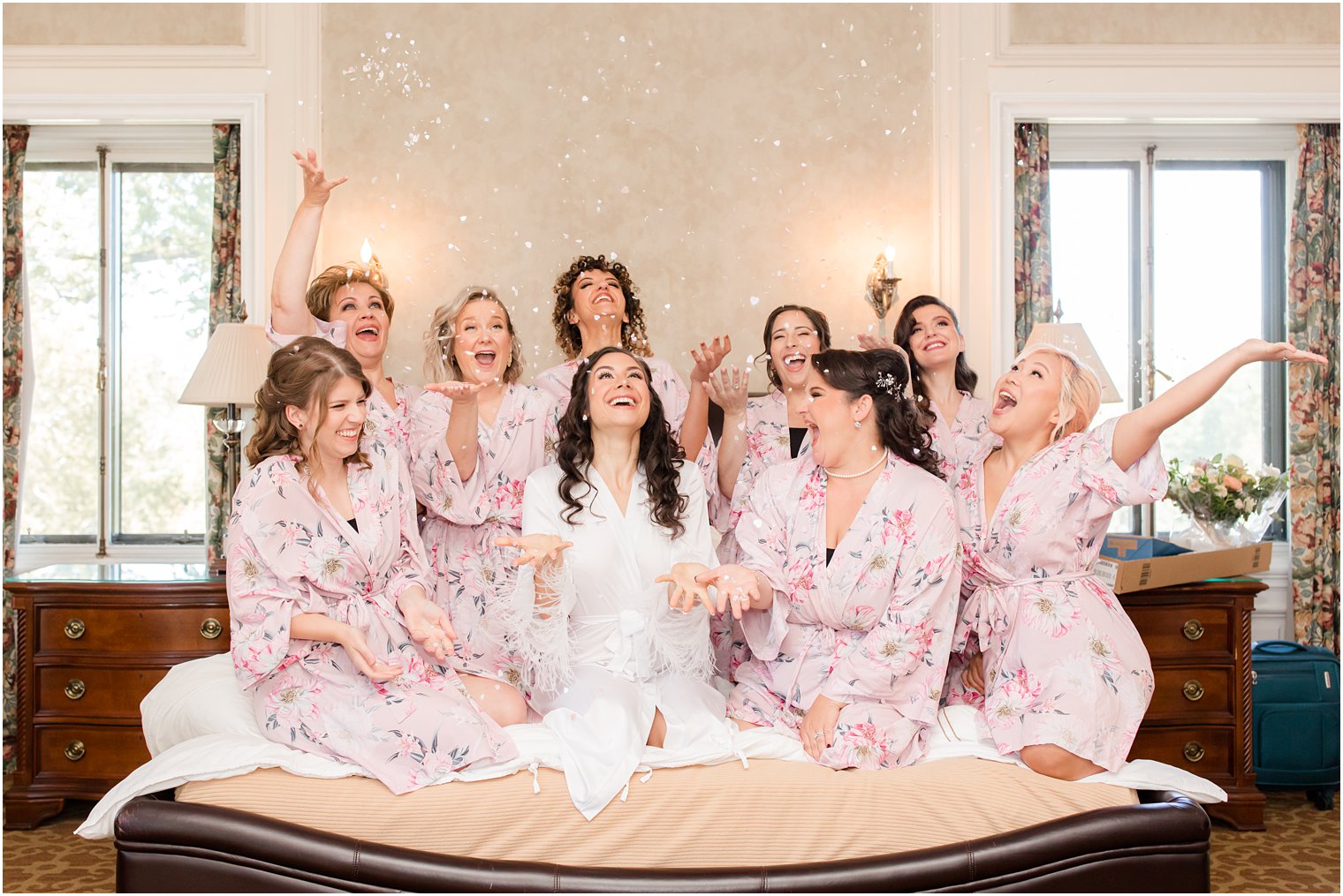 bride and bridesmaids toss confetti before Village Club of Sands Point wedding