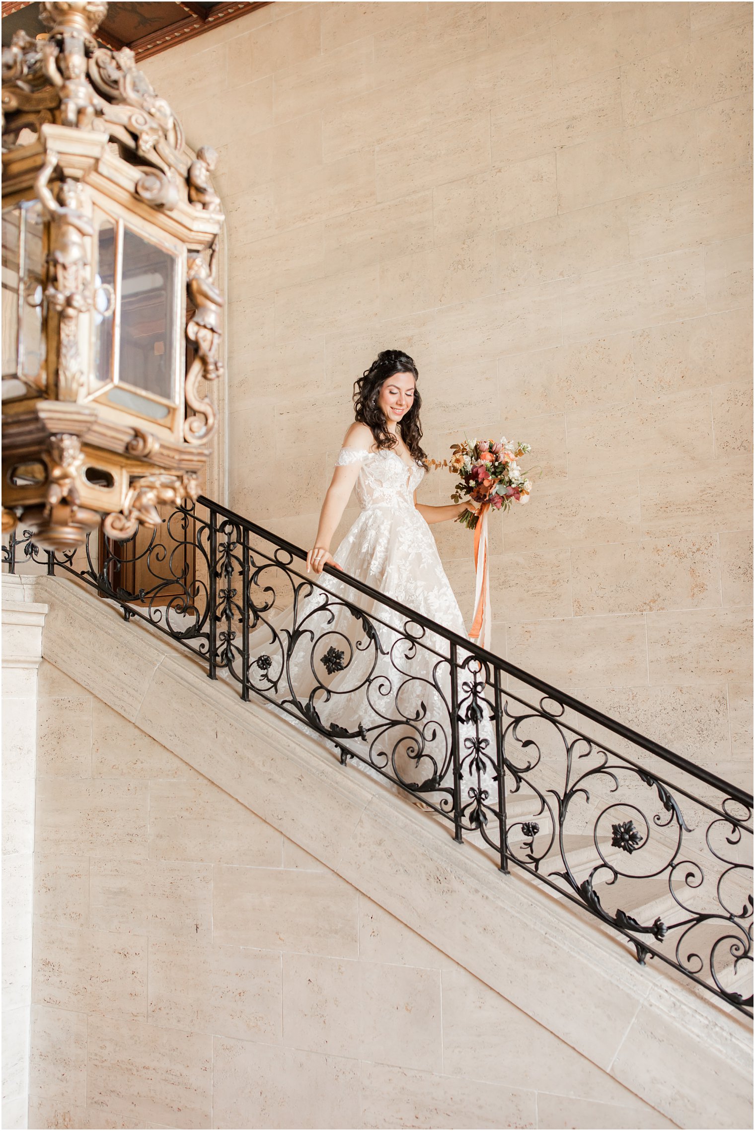 bride walks down staircase at Village Club of Sands Point