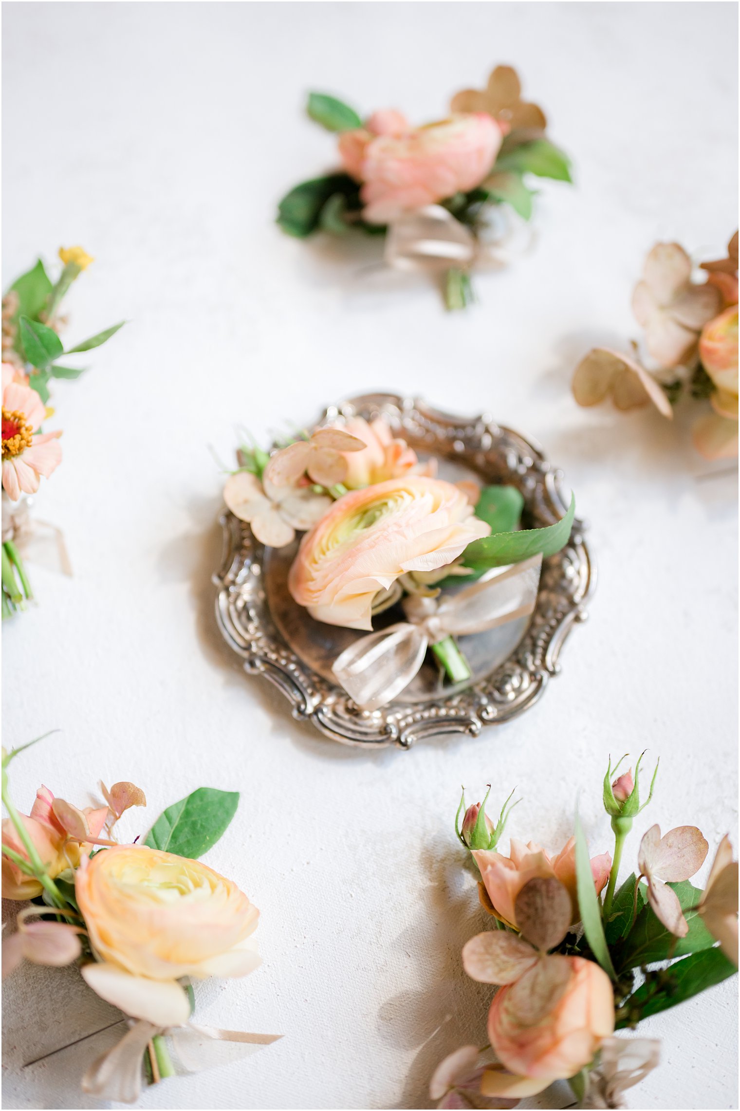 peach floral boutonnieres for groom