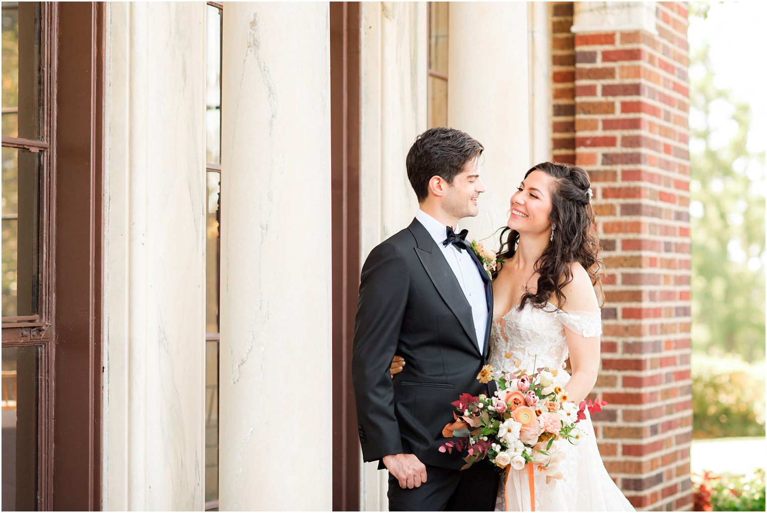 newlyweds hug looking at each other during portraits in Sands Point NY