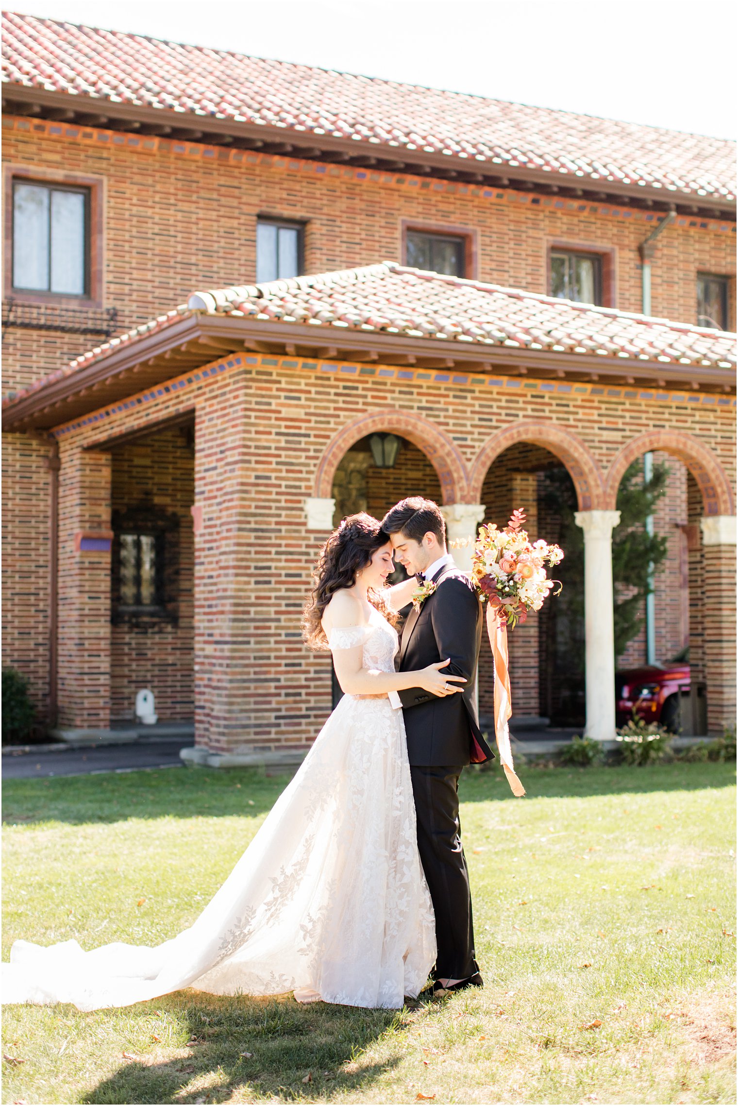 bride and groom lean heads together during Village Club of Sands Point wedding portraits 