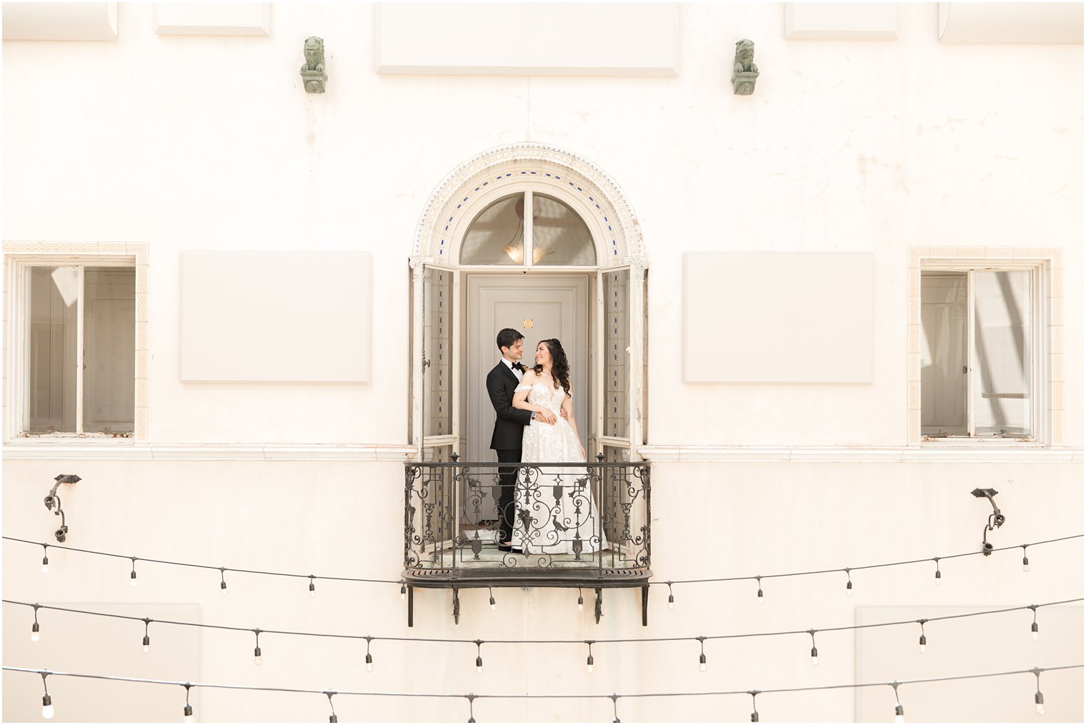 bride and groom pose on balcony at the Village Club of Sands Point