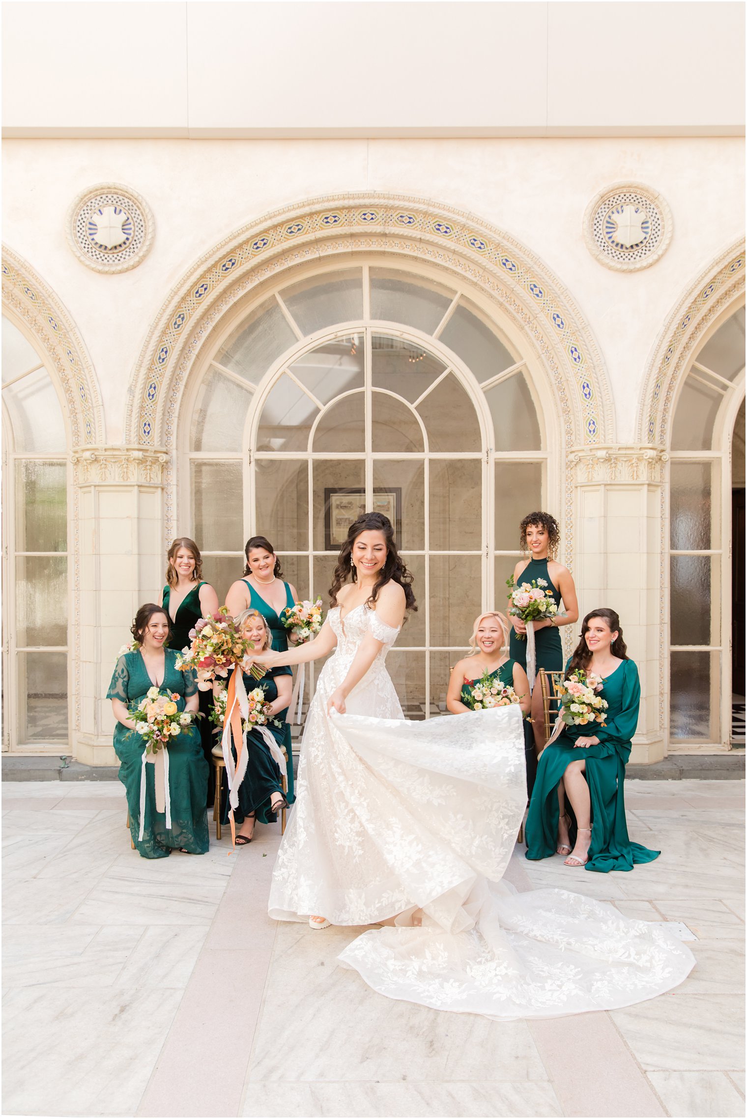 bride twirls wedding gown with bridesmaids looking at her