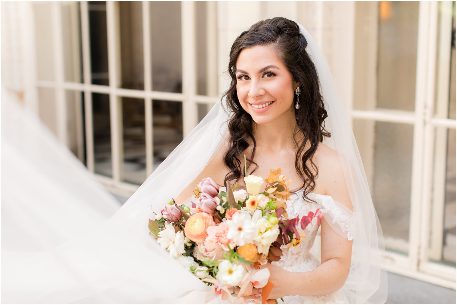 bride holds bouquet of fall flowers at the Village Club of Sands Point