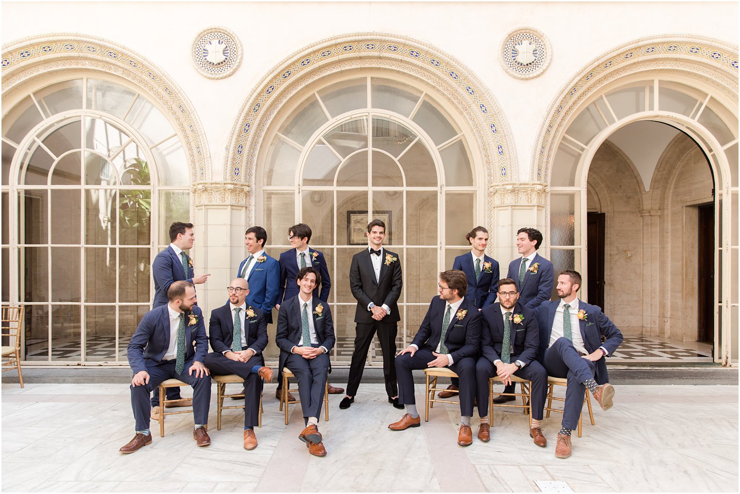 groom and groomsmen pose outside the Village Club of Sands Point