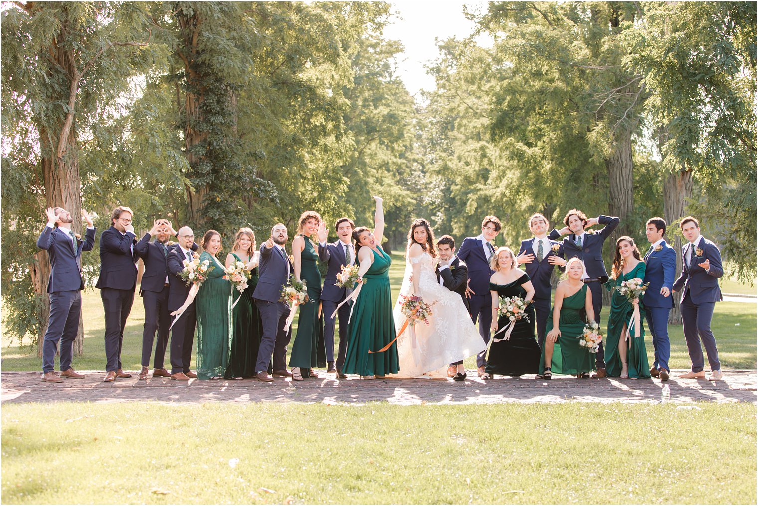 bride and groom pose with wedding party outside the Village Club of Sands Point