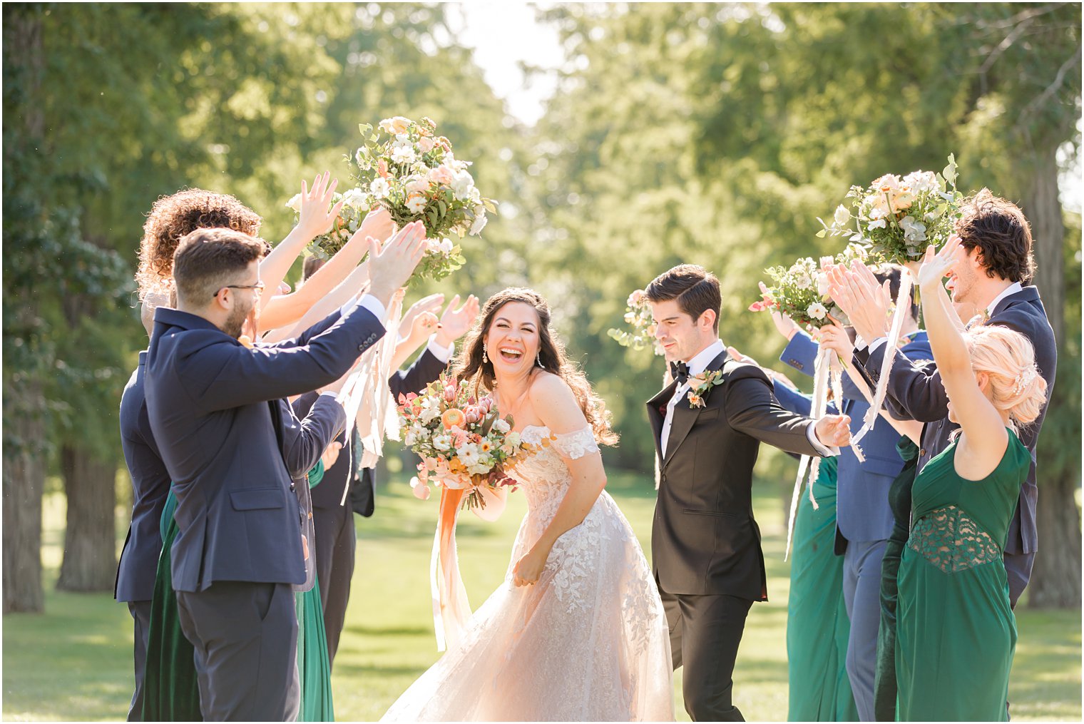 newlyweds dance with wedding party outside NY wedding venue 