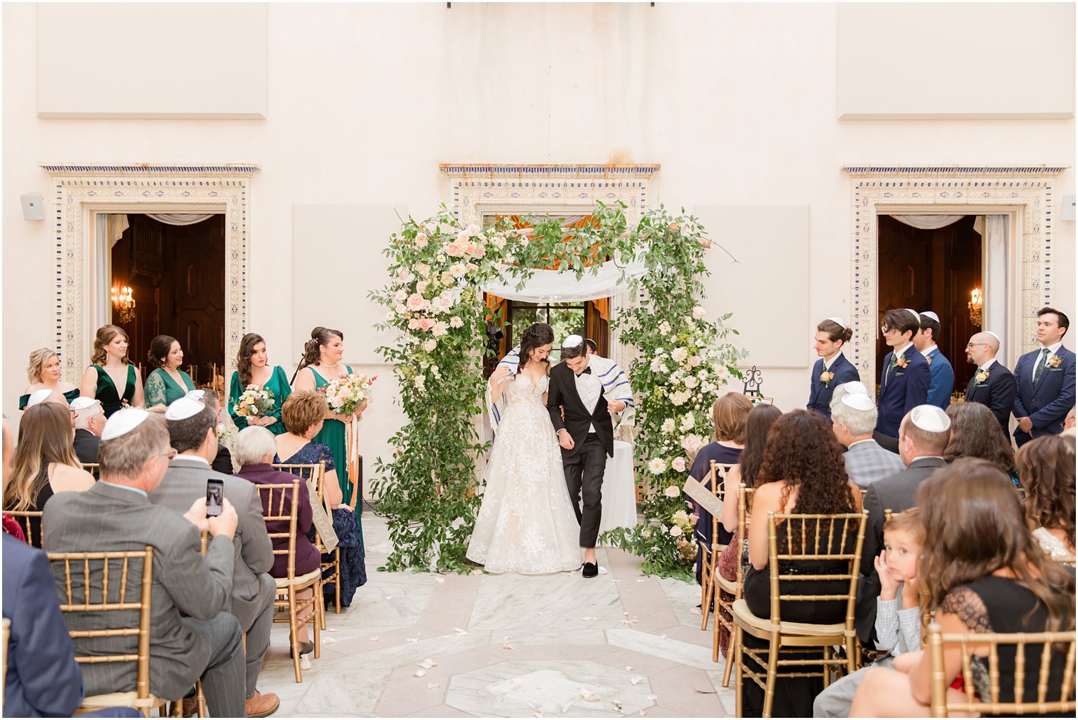 Jewish bride and groom break glass on wedding day