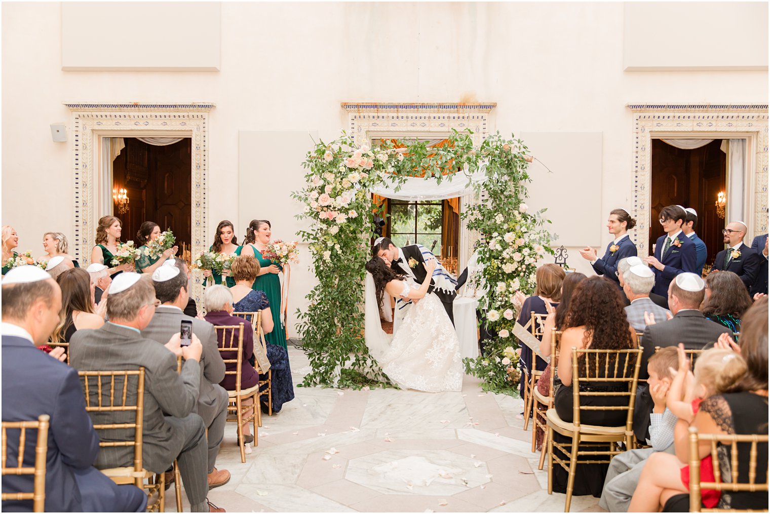 groom dips and kisses bride at the Village Club of Sands Point