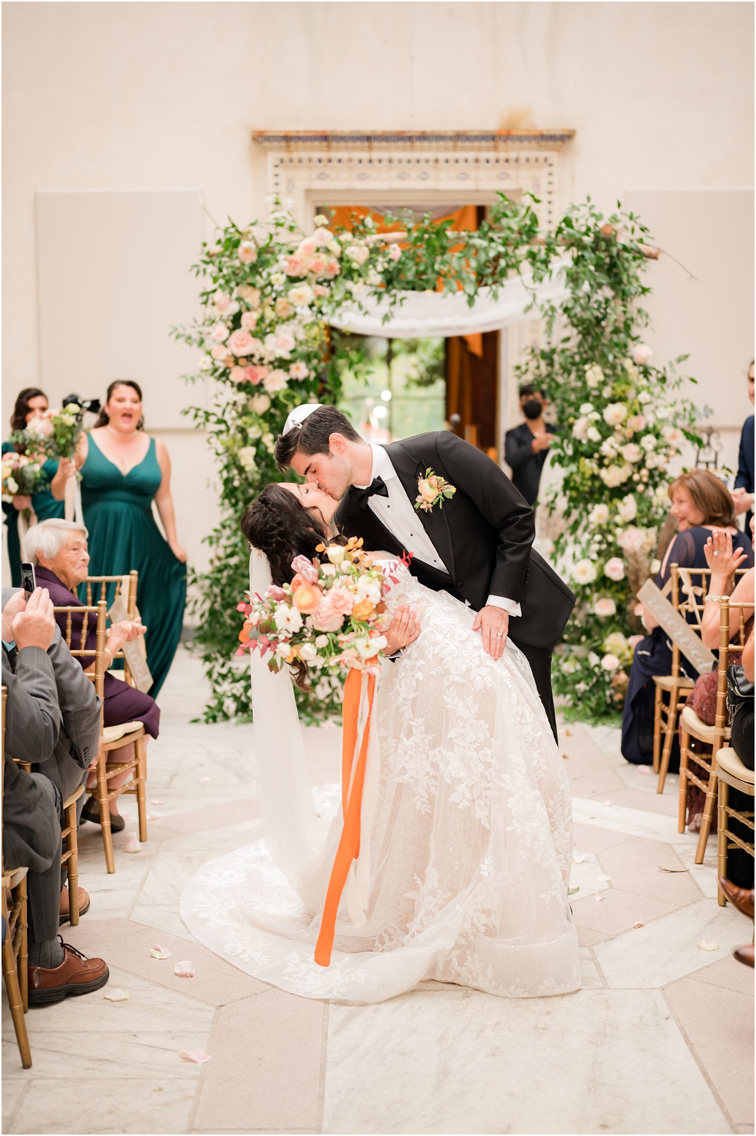 newlyweds kiss in aisle at the Village Club of Sands Point