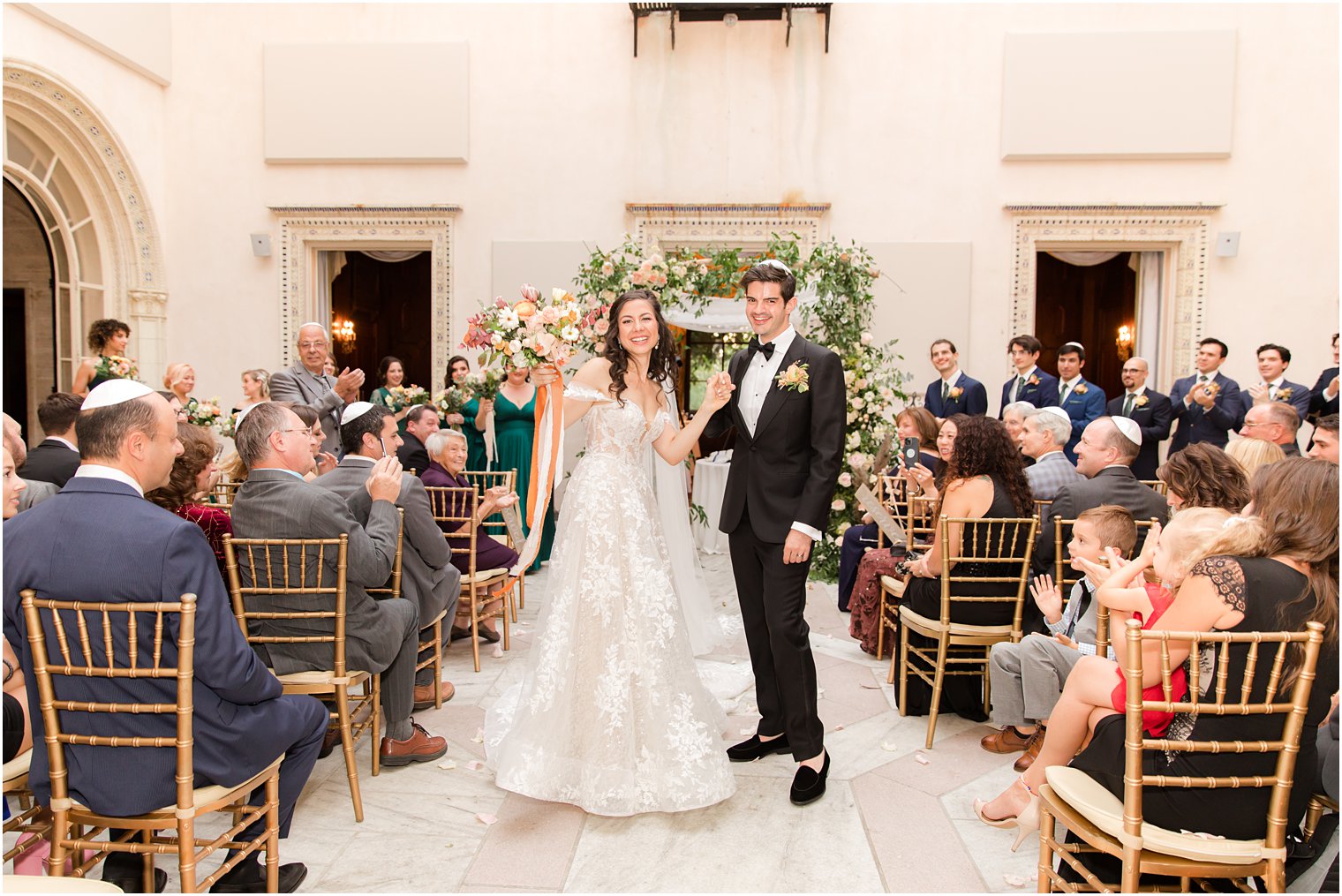 bride and groom cheer in aisle of the Village Club of Sands Point